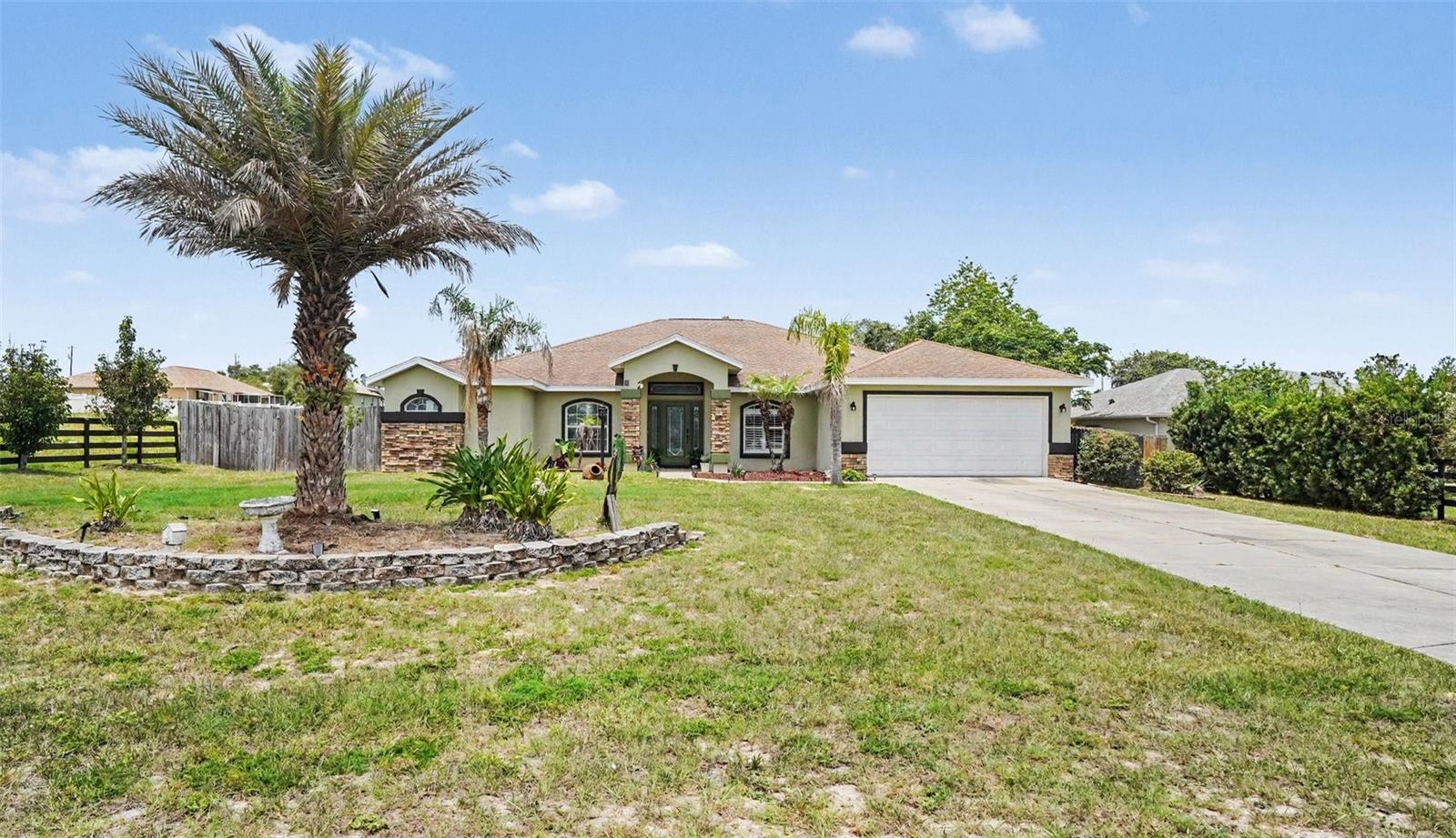 From the moment you arrive, this home sets the stage for easy living and unforgettable gatherings. This beautifully maintained 4-bedroom, 2.1-bath property sits on a spacious half-acre lot, offering a fully fenced backyard complete with an above-ground pool and a patio perfect for relaxing or entertaining. Added convenience comes with a half bathroom located just off the patio—ideal for guests enjoying the outdoor space and pool.
As you step inside, you’re welcomed by a bright, open entryway with soaring vaulted ceilings that flow seamlessly into the spacious family room and centrally located kitchen, truly the heart of the home. Just off the kitchen, a newly updated theater room creates the perfect spot for movie nights, with easy access for grabbing snacks. The primary suite is impressively sized, offering a comfortable and private retreat. Enjoy Florida living year-round with both a covered and screened lanai and outdoor covered patio space, plus the added convenience of a 2-car garage. This home offers the perfect blend of space, functionality, and lifestyle.