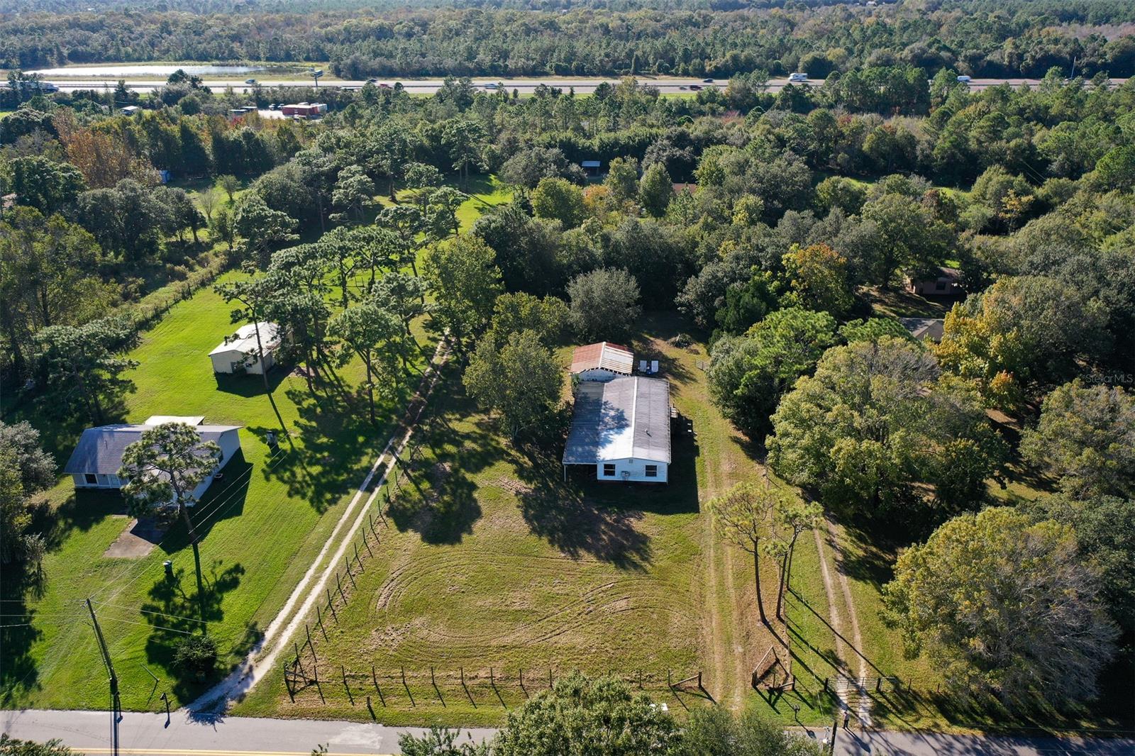 Beautiful 1.2 Acre mostly cleared & fenced lot conveniently located near I-95 and US1! Less than 30 minutes to New Smyrna Beach and/or Titusville, 40 minutes to Cape Canaveral, 60 minutes to Orlando! Included is a 5 bedroom, 2 bath, 1971 manufactured home that can be a fixer upper for the handy buyer or removed to put a brand new home in! Property has electric, well (with newer pump & tank), septic (was redone in approximately 2010) and has a 25x30 detached garage that can be used as a workshop/storage/small business. Loads of potential with impact fees already paid! Horses, cows, goats, chickens OK! Plenty of room to create your own vegetable garden. Private lender financing may be available with 40% down. Ask me how!