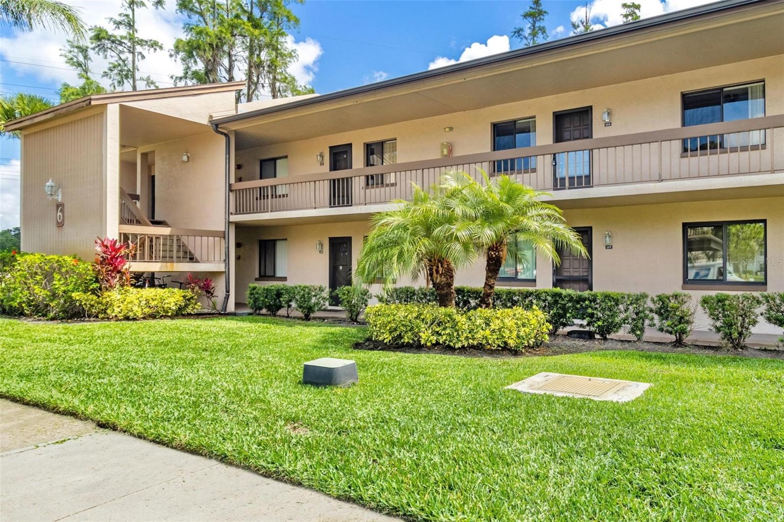 This adorable 2nd floor, 2 bedroom, 2 bathroom condo in the guarded/gated community of East Lake Woodlands! An open and airy front balcony welcomes you in to the unit. NO REAR NEIGHBORS! Just views of the lovely back yard wooded area and daily deer sightings from your 2nd balcony which is private and screened-in! A big picture window, recessed lighting, solid wood cabinets and tiled backsplash accent the kitchen. The kitchen has a floor to ceiling pantry and is open to living / dining with an breakfast bar. An elegant, 2 tiered chandelier, crown molding and new modern ceiling fan grace the ceiling. Newer laminate flooring installed in the living /dining and both bedrooms. Step through the living room sliding doors and onto the screened-in balcony where the true Florida lifestyle begins. Roller shades on the balcony create privacy while still allowing the cool breezes to flow through. This unit features a split bedroom plan with NO CARPET! Master bedroom has its own bath en suite with separate shower/commode area, 3 walk in closets (YES! 3), tropical ceiling fan with palm leaf blades, double picture window with beautiful views of the wooded back yard! It is spacious enough for a king bedroom furniture set and also has a set of sliding doors out to the balcony! Guest bedroom features a large closet and an adjacent full bathroom with tub/shower in the hall. No lack of storage here with a coat closet in the main entry hall and a full wall to wall reach in closet in the guest hallway. A side by side washer and dyer are conveniently located in the balcony closet. Your assigned covered parking spot is right in front of the entrance (#108). Plenty of extra guests spots for a 2nd car too. Heated pool just steps away! Love to golf? East Lake Woodlands County Club will become your new favorite spot with (2) 18 hole championship courses, upscale restaurant, fitness center, clubhouse, tennis courts, 2 pools and a multimillion dollar renovation underway! Located just around the corner from Oldsmar sports complex on Tampa Rd with a playground, ball hockey rink, BMX supercross track and fields for baseball football and soccer. Adjacent to the complex is Woodlands Square Mall with an IMAX movie theater, gourmet restaurants and shopping. East Lake Rd houses 2 large shopping centers with Target, Walmart, and an assortment of fast food chains. Short drive to Countryside mall, Tampa Airport, and the sugar sands of the Gulf’s finest beaches. Bring your furry friends! Two cats or dogs allowed under 20 lbs each (or a total of 40 lbs between the 2). Low condos fees with water, sewer, trash and basic cable included. Make your appointment to see today!