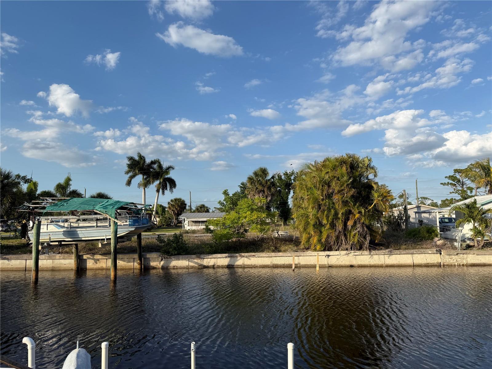 Rare waterfront opportunity in historic El Jobean. This desirable Hollis Avenue homesite offers approximately 100 feet of deep-water sailboat canal frontage with no fixed bridges, providing outstanding access for boating enthusiasts. Enjoy quick access to nearby boat ramps, marinas, golf courses, parks, churches, live entertainment, and local art venues. Known for some of the best fishing on Florida’s Gulf Coast, this area is a dream location for anglers and boaters alike. Conveniently located near Port Charlotte Town Center, Charlotte County Fairgrounds, and Tampa Bay Rays spring training facilities. Lot will require clearing and cleanup, creating the perfect chance to design your custom waterfront retreat or investment property. Opportunities like this are limited—start planning your Florida lifestyle today. Call for details.