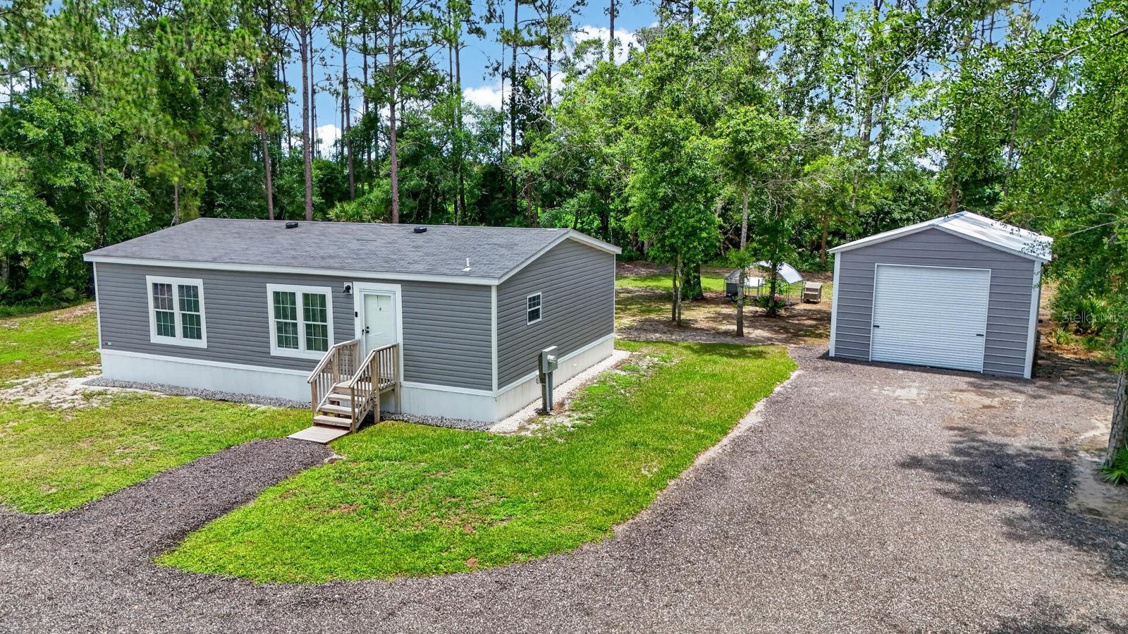 Welcome to 4825 Pecan Avenue in Bunnell, Florida, this beautifully maintained 2024 model manufactured was placed in a gorgeous country setting in 2023, offering modern comfort, peace of mind, and plenty of room for all your toys. Situated on a just over an acre of land, this 1,040-square-foot home features a bright, open floor plan designed for easy living and low-maintenance ownership.
Recent upgrades include a whole-home water filtration system, a brand-new water heater, and a newly installed septic pump that is still under warranty, providing added value and confidence for the next owner.
One of the standout features of this property is the impressive 18’ x 30’ metal garage, offering ample space for boat storage, recreational vehicles, workshop space, equipment, or additional storage. Whether you’re an outdoor enthusiast, hobbyist, or simply need extra room, this versatile structure is a rare find.
Enjoy the tranquility of country living while still being conveniently located near shopping, dining, schools, and the beautiful beaches of Flagler County. This move-in-ready property combines modern amenities, practical upgrades, and exceptional storage option, making it an opportunity you won’t want to miss.