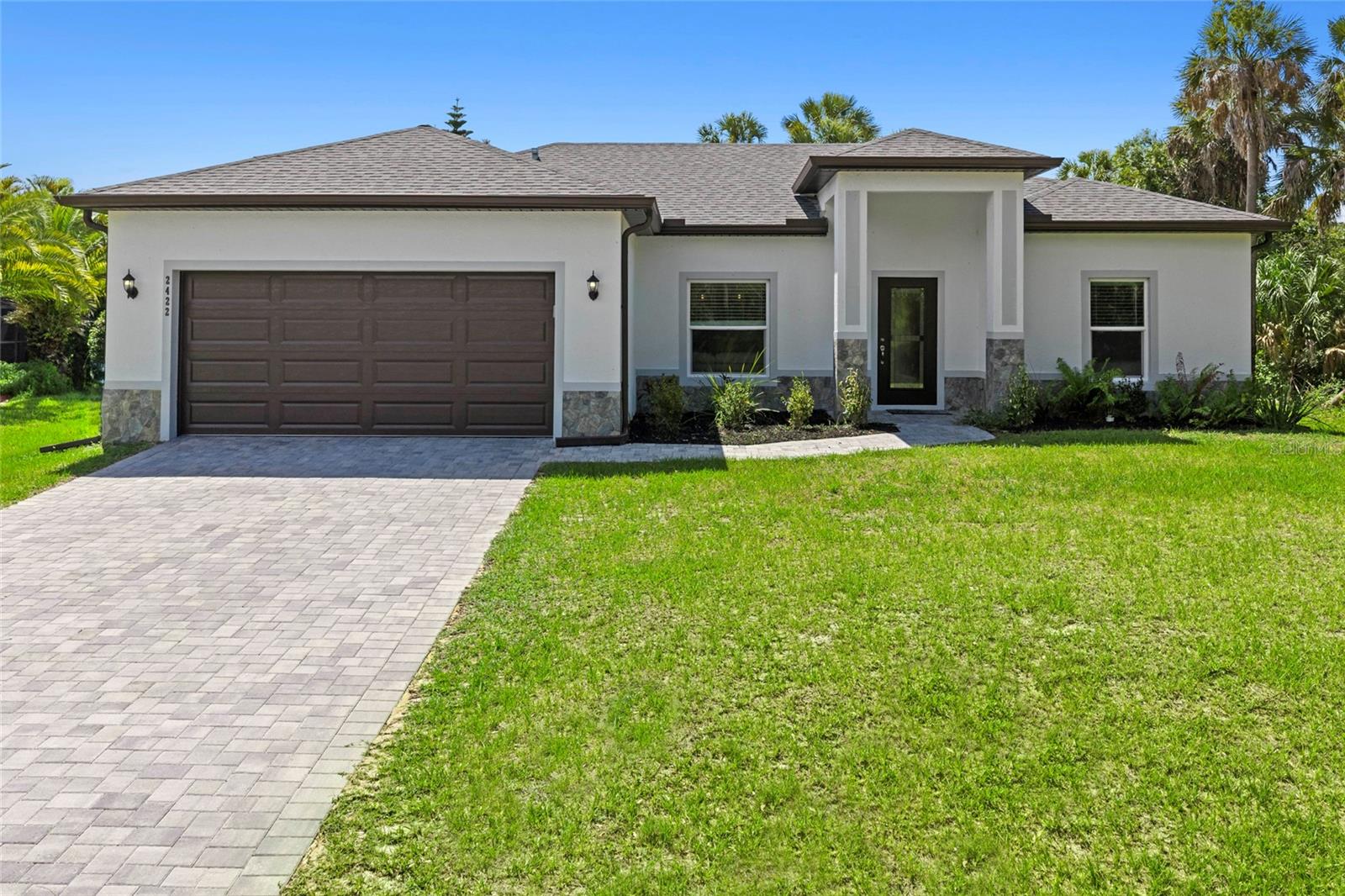 Welcome to this immaculate, 3 bedroom, 2 full bathroom residence where modern elegance meets effortless Florida living. Thoughtfully designed with an expansive open-concept floor plan, the home is filled with natural light and showcases sleek tile flooring that flows seamlessly throughout the main living spaces. At the heart of the home, the beautifully appointed chef’s kitchen impresses with thick granite countertops, crisp white shaker cabinetry extending to the ceiling for exceptional storage, and a full suite of stainless steel appliances including a side-by-side refrigerator with ice maker, range, microwave, and dishwasher. Designer pendant lighting highlights the oversized breakfast bar, creating the perfect setting for casual dining, entertaining, or gathering with family and friends. Recessed lighting throughout adds a sophisticated contemporary touch. The spacious great room is anchored by an elegant tray ceiling with ceiling fan and effortlessly connects to the dining area and kitchen, creating an ideal flow for both everyday living and entertaining. Sliding glass doors open to the backyard, blending indoor and outdoor living for the ultimate Florida lifestyle experience. Privately situated, the primary suite serves as a serene retreat featuring a tray ceiling, ceiling fan, and peaceful backyard views. Two additional generously sized bedrooms each offer ceiling fans and oversized windows that bathe the spaces in natural light. One bedroom offers exceptional flexibility and can easily function as a home office, guest suite, or hobby room to suit today’s lifestyle needs.
Both full bathrooms are thoughtfully designed with comfort and functionality in mind. Completing the home is a spacious garage providing secure parking and additional storage. Impeccably maintained and move-in ready, this stunning residence offers the perfect blend of style, comfort, and modern convenience. Is this home your perfect match?

**THIS PROPERTY QUALIFIES FOR A 1% LENDER INCENTIVE IF YOU USE A PREFERRED LENDER. INQUIRE FOR MORE DETAILS!**