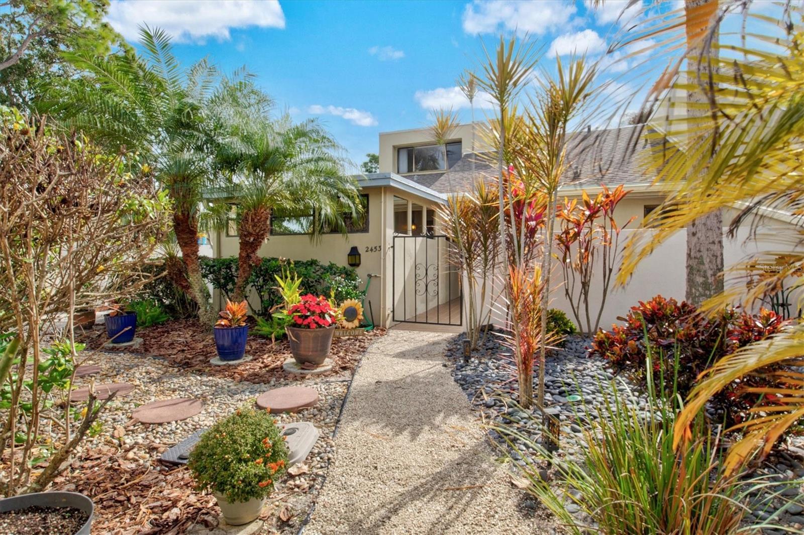 One or more photo(s) has been virtually staged. Captivating Views on Crispin Court. Located within the sought-after community of The Meadows in Sarasota, this beautifully remodeled THREE-BEDROOM, two-bath villa offers 1,608 square feet of thoughtfully designed living space, along with a versatile bonus area ideal for a home office, study, or flexible living needs—a feature not typically found in Meadowlake units. The A/C and hot water tank were REPLACED in 2022.
This residence enjoys UNOBSTRUCTED WATER-VIEWS from the downstairs primary bedroom, living room, and an upstairs bedroom, all complemented by a picturesque golf course fairway in the distance, creating a serene and private setting. The two-story floor plan features a first-floor primary suite with an UPDATED en-suite bathroom and ample closet space. The spacious living and dining areas showcase VAULTED CEILINGS, enhancing openness, natural light, and the home’s connection to the outdoors. Upstairs, two additional bedrooms provide comfort and privacy, ideal for guests or added flex space.
The kitchen is well-appointed with granite countertops, abundant cabinetry, generous storage, a newer refrigerator, and a pantry, offering both functionality and timeless appeal. NEWLY INSTALLED luxury vinyl flooring runs throughout the home, while the entire interior has been freshly painted, providing a clean, move-in-ready presentation. Just beyond the living space, a screened-in lanai offers an inviting open-air seating area, perfect for morning coffee, evening relaxation, or enjoying peaceful water views—an ideal extension of the indoor-outdoor lifestyle.
The surrounding landscape, both around the home and throughout The Meadows, feels more like a park with homes rather than a dense subdivision. Residents enjoy an active, amenity-rich lifestyle spanning over 1,650 acres of mature oak canopies, scenic lakes and waterways, golf courses, tennis courts, new pickleball courts, a fitness center, 14 miles of walking and bike trails, and a junior Olympic-size community pool. The Meadowlake neighborhood also offers TWO PRIVATE POOLS. Conveniently located near shopping, dining, cafés, University Towne Center (UTC), Mote Marine Aquarium, cultural attractions, and approximately 13 miles to Sarasota’s renowned beaches, this villa offers comfort, lifestyle, and an exceptional location.
Schedule your private showing today to experience the setting, views, and quality this Meadowlake villa offers—an exceptional opportunity within one of Sarasota’s most established communities.