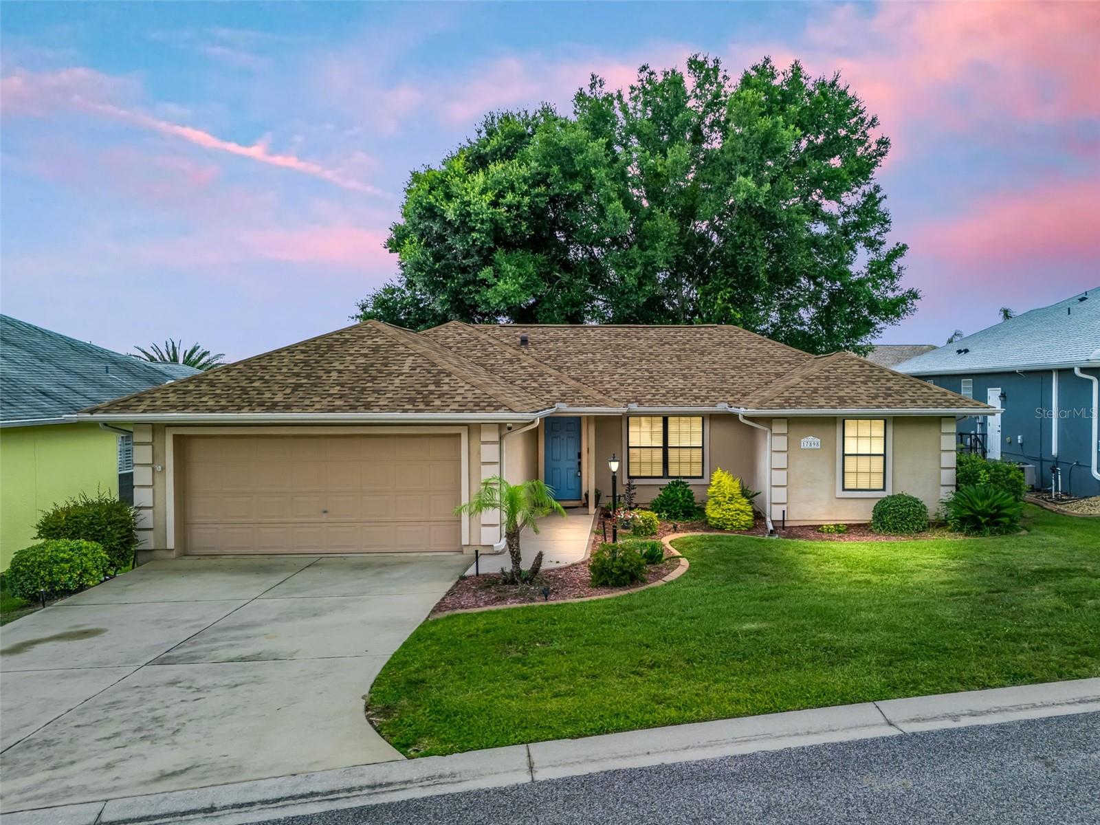 Stonecrest is a 55+ gated golf course community with all the amenities and 4 pools (one indoor), and just a Bridge Away By Golf Cart To The Villages! Immaculate 3/2 Lilly with a 2 Car Garage, ROOF 2024! HVAC 2022!  Water Filtration System!  Low Maintenance Professional Landscaping! The Open Concept and Split Floor Plan, offers an exceptional floor plan with plenty of Space, and Natural Light, making the Lilly model just perfect for Entertaining Friends and Family! This well designed home boasts Vaulted ceilings, No Carpet, and a Screened Lanai with a Birdcage attachment! The Spacious Kitchen showcases Granite countertops, Stainless appliances, Solid Wood cabinetry with Pullouts, a Pantry closet, Breakfast bar, a Butler's to the Dinning area, and an Eat in Area with Built in Counter accented by Beautiful Bay Windows! The kitchen flows to the Dining area with access to the lanai, and combines with the 18 x17 Living area providing an exceptional space for enjoying comfortable living, and entertaining! The Split Floor Plan offers the utmost Privacy for both the Owners and their Guest, with the Primary suite commanding one side of the home while the guest bedrooms and guest bathroom are located on the opposite side of the home.  The Primary suite provides Private sliding door Access to the Birdcage covered back patio, a Walk in Closet, and an En Suite bathroom. The En Suite bathroom showcases a Two sink vanity, and a Walk in Shower. The two additional bedrooms feature nice size built in closets, and the guest bathroom has a Tiled tub and shower combination, providing your guests with plenty of Space, and Privacy! Retreat to your own outdoor Oasis, on the Screened Lanai with beautiful painted concrete flooring which continues through to the Birdcage covered Back Patio, with Privacy landscape, enhancing the outdoor living experience! Enjoy outdoor BBQ's, Sunset Dinners, and the beautiful Florida weather in the beautiful backyard parklike setting! All your storage needs will be met in the 19 x 20 2 Car Garage with added shelving!  Stonecrest is a 55+ gated golf course community with all the amenities, private roads, pools, pickleball courts, softball, 18 hole championship golf course, Broad Stripes Golf & Social Club and over 80 different clubs to join! As a Gated Golf Course Community, you can expect a high level of Privacy and Security. Overall, this home offers a combination of Great Outdoor Space, a Fantastic Floor Plan, a Desirable Location, and a Secure Community Setting. A WONDERFUL LIFESTYLE AWAITS YOU IN STONECREST!