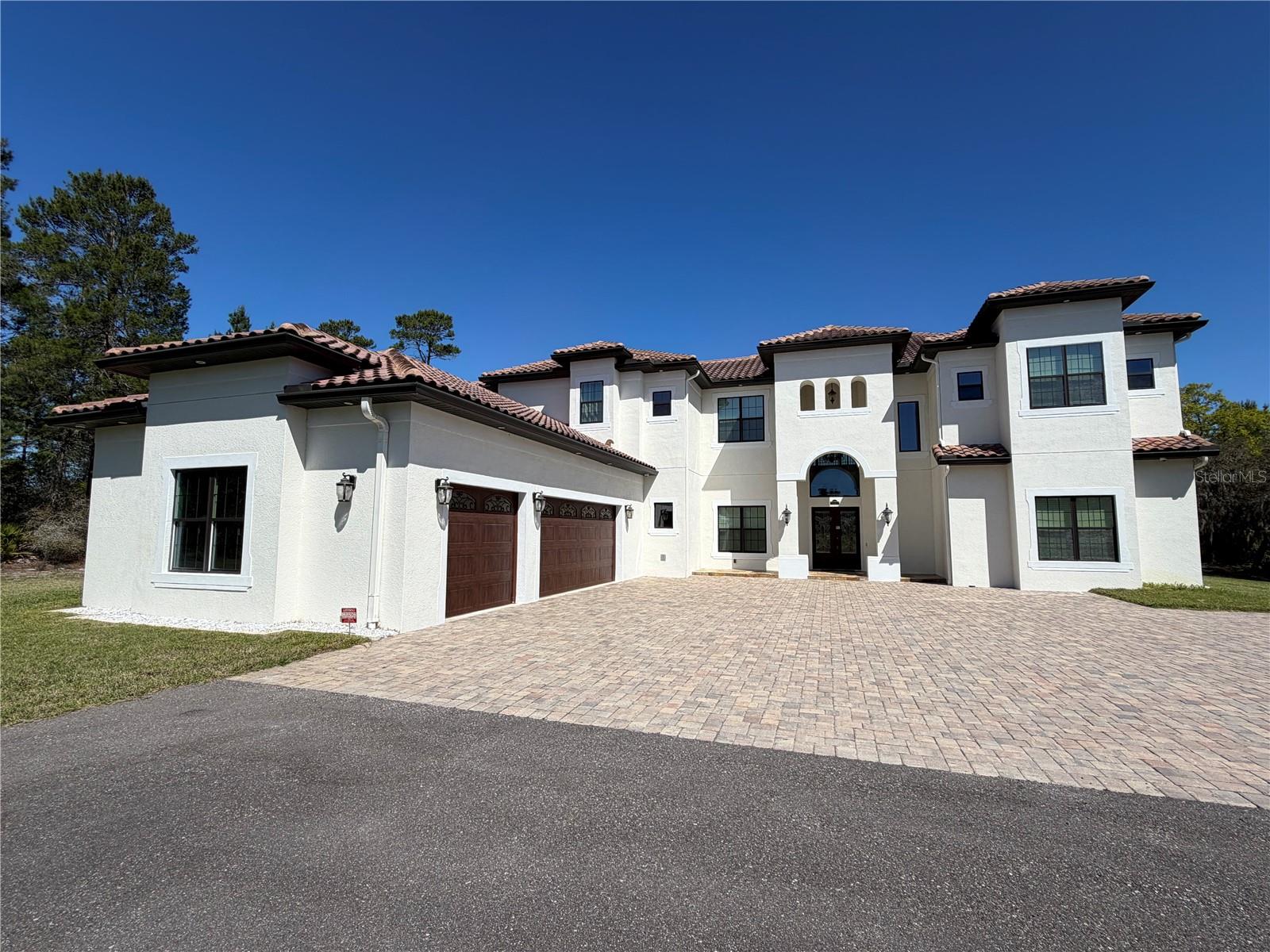 ONE OF A KIND! MUST SEE!

Experience timeless elegance combined with the tranquil ambiance of over 5 acres, just minutes away from Lake Nona! It is extremely rare to find the luxury of an AC-zoned lot that allows for farming, horses, cattle, and more, while still being within the vicinity of the city. This custom-built home epitomizes excellence with approximately 7,000 sq ft of living space and an oversized 3-car garage.

As soon as you walk in, you will feel the 20+ ft high ceilings and see the dual pocket slider glass doors that allow ample light to brighten your day. The thoughtful floor plan includes 6 ensuite bedrooms for ultimate privacy, an office/study room, and a playroom. The dual master bedrooms feature a covered lanai and a covered balcony with a view overlooking the enormous backyard.

Regarding the meticulous build quality, the home includes Carrier variable speed HVAC with humidity control, Icynene attic insulation, concrete barrel tile roofing, MI windows, PGT doors, and oversized 2 by 6 framing upstairs to fit more insulation. This brings your electric bill down to that of a home half its size. The oversized chef’s kitchen boasts luxury Wolf appliances, including a commercial-style 48-inch gas range top with a dual motor hood and a pot filler faucet, as well as natural stone to match the high-caliber build quality.

Other unique upgrades include a wet bar, a server room with Hudson security monitoring and recording, a mechanical room for easy HVAC servicing, an upstairs laundry chute, and ample hidden storage throughout the home. The patio features multiple areas on sealed travertine for versatile use and a custom outdoor kitchen. A guest bathroom is conveniently placed by the patio for future pool expansion. Pool drawings are available!

This home has the fundamentals taken care of, and the customization possibilities for final touches are endless with this lot size. This home is a must-see masterpiece that is priced to sell. Schedule your showing today!