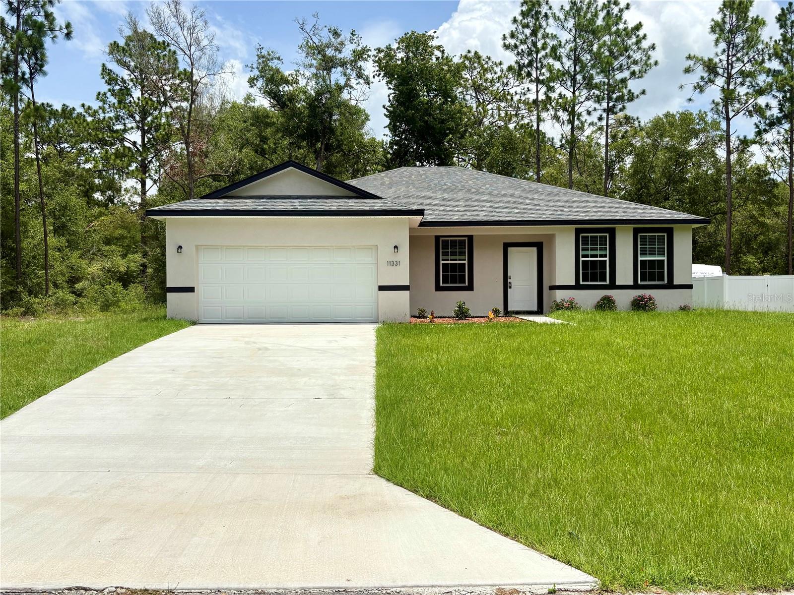 A peaceful setting surrounded by nature, featuring a spacious and cozy home. It includes four bedrooms: a master suite with room for a king-size bed, two large walk-in closets, and a roomy bathroom with double sinks and a glass-enclosed shower; a guest suite that also features a walk-in closet; and two additional guest bedrooms with easy access to a guest bathroom. The home boasts an open-concept layout with a quartz-countertop kitchen—featuring a spacious island and new appliances—flowing into a large living area with ample space for a dining table. There is a covered back porch and a yard perfect for relaxing or hosting family gatherings. Washer and dryer are included, and the garage accommodates two cars. Contact us to schedule a visit.