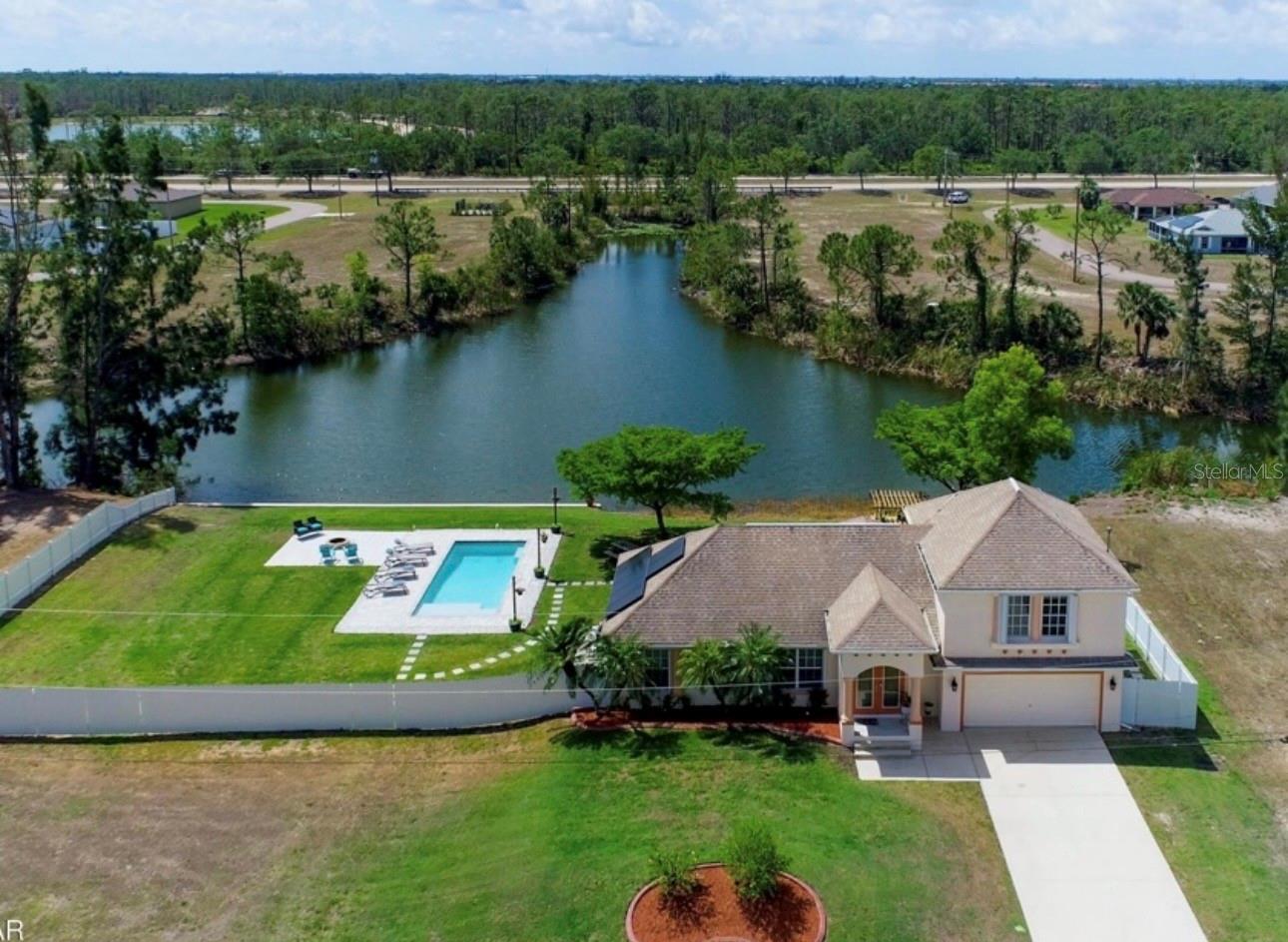 Waterfront Luxury | Double Lot | New Roof | Heated Pool | Canal Views | No Flood Zone

Stunning 3BD/2BA, 1,614 sq ft two-story waterfront home on a rare double lot in Cape Coral with freshwater canal access and over $60,000 in recent improvements — truly move-in ready with every major ticket item already handled.

Wake up and step onto your private second-floor balcony with sweeping canal views, then head downstairs to launch your kayak, paddleboard, or small boat right from your backyard. Spend afternoons floating in the heated pool with color-changing LED lights, elegant fountains, and sun shelf — by day a sparkling resort escape, by night a glowing backyard showpiece. End your evenings around the fire pit as the breeze rolls off the water, string lights swaying overhead.

The oversized pergola is ready to become your dream tiki bar or garden retreat, and the fully fenced yard with 6’ privacy fencing on both sides creates a true private oasis. The aerial views tell the full story — this lot is genuinely exceptional and rarely available in this area.

Inside, the open floorplan and soaring vaulted ceilings make an immediate impression, anchored by a striking designer staircase with custom board-and-batten molding and statement sconces. Beautiful lead glass entry doors and arched doorways add architectural character throughout. The kitchen features stainless appliances and flows naturally into the living area. The primary suite is a genuine retreat — spacious and serene, with a private loft, large soaking tub, marble vanity, and direct sliding door access to the water-view balcony. Every bedroom has its own personality and the home is carpet-free throughout.

The 2-car garage includes laundry, generous storage, conveniently located near community park and just minutes from major area amenities.

Every Major Ticket Item — Already Done For You:

• Brand new roof (2026) — insurance-ready from day one

• New AC system (2024) — full system replacement

• New water heater (2023)

• Paid-off solar panels

• Whole-house water softening system

• Hurricane shutters throughout

• Heated pool with color-changing LED, fountains & sun shelf (2021)

• Screened porch, storage shed, outdoor furniture & pool chairs included

Proven rental income at $3,650/month. No flood zone. No HOA. Minutes from Cape Coral Beach, Downtown Cape Coral, and Downtown Fort Myers.

Tenant occupied through August 31, 2026.    Welcome home!