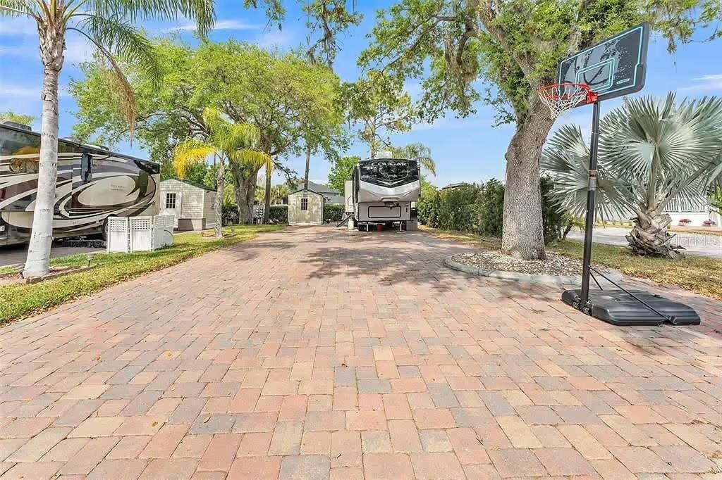 This is your chance to own a deeded lot in the beautiful, gated Elite Resorts at Citrus Valley! You can park your RV or add a Park Model home in this extra wide and extra-long paved lot, and it backs up to the perimeter fence, so no neighbors behind you! This lot comes with a 10x10 shed equipped with a solar light. While there is plenty of grass on the both the side and the back, there is also plenty of available space to add additional pavers if you desire! There are full RV hookups, ample parking, palm trees, and a large oak tree at the front for additional shade. This RV resort is home to 305 total lots and only 12 miles from Walt Disney World Resort. This is a top tier resort that offers numerous amenities, such as a full laundry facility, two bathhouses with showers, an exercise room, putting green, community pool with nighttime lights, regular bingo games during the season, a Veteran's group and memorial, clubhouse that is available for rent (no cost), and a variety of entertainment and shows! The $786 quarterly HOA fees include lawn cutting, high speed internet, cable, sewer, water, and trash services. You can live here year-round or rent it out when you are gone! Owner financing may be available. Call me today to schedule your showing!