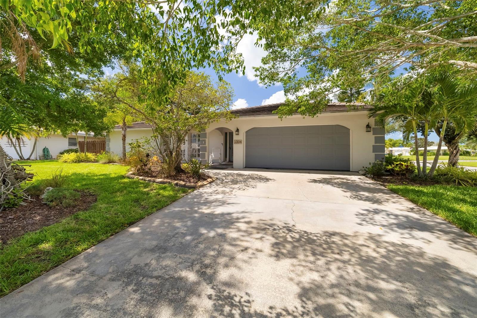Offering remarkable pool home with an outstanding Sarasota location, this low HOA fee community in Village Green Club Estates delivers the perfect combination of comfort, functionality, and Florida living. Situated on a spacious corner lot, this solid block home features a thoughtfully designed split-bedroom floor plan, multiple living areas, and a private backyard retreat—creating an ideal setting for everyday living and entertaining.

Inside, the bright and open layout provides exceptional flexibility with a spacious living room and separate family room, giving everyone room to gather or unwind. An electric fireplace adds warmth and ambiance, while the functional design allows for seamless flow throughout the home.

The split-bedroom floor plan offers outstanding privacy for owners and guests alike. The spacious primary suite is tucked away on one side of the home and features a large walk-in closet and private en-suite bathroom. Two additional bedrooms are positioned on the opposite side of the home and share a full bath with direct access to the pool, making it ideal for guests and outdoor entertaining.

Step outside to your private backyard oasis. The newly resurfaced pool is perfect for enjoying Florida’s year-round sunshine, while the covered lanai provides a comfortable space for outdoor dining or relaxing overlooking the fully fenced backyard.

The home has been exceptionally maintained, with major improvements already completed for added peace of mind. A new roof was installed in 2020, the air conditioning system was replaced in 2022, and most of the kitchen appliances have been updated within the past few years, allowing the next owner to move in with confidence.

Village Green Club Estates is one of Sarasota’s most established neighborhoods, known for its mature landscaping, beautifully maintained homes, and remarkably low HOA fees. Residents also enjoy the nearby Village Green Golf Club, where affordable annual and monthly membership options make it easy to enjoy golf, dining, and an active social atmosphere without the obligation of mandatory membership.

Situated in the heart of Sarasota off Bee Ridge Road between US-41 and I-75, this home is just minutes from Downtown Sarasota, Siesta Key Beach, Lido Beach, the Legacy Trail, Payne Park, Sarasota High School, Brookside Middle School, and the Sarasota Art Museum. Enjoy convenient access to Sarasota’s renowned dining, shopping, cultural attractions, Big Olaf Ice Cream, Yoder’s Fresh Market, the YMCA, Locklear Park, and the area’s beautiful Gulf beaches.

This is a rare opportunity to own a beautifully maintained pool home in one of Sarasota’s most desirable established communities. Combining major system updates, low HOA fees, optional golf membership, and an unbeatable central location, this home offers the perfect Florida lifestyle. Schedule your private showing today.