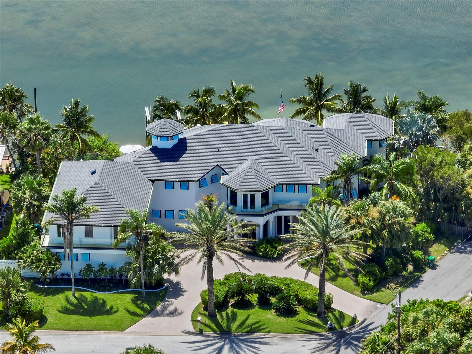 Under contract-accepting backup offers. Updated in 2022, welcome home to your luxurious waterfront estate with 5 bedrooms, 5.5 baths, and over 6,558 square feet. Experience endless coastal paradise with 150 feet of Banana River frontage, breathtaking unobstructed views, dolphins swimming in your backyard, boat access to the Atlantic Ocean, nearby beaches in the Surf Capital of the East Coast and iconic rocket launches from Kennedy Space Center. This exquisite compound offers a blend of luxury and comfort, and is designed to maximize natural light and stunning water views. The chef’s kitchen is ideal for entertaining and features two islands, two dishwashers, three chef sinks, custom-designed stone countertops and backsplash, high-end appliances and cabinets, six-burner gas stove, wine cellar and a butler's pantry. Along with the gourmet kitchen, the private home office and gym are on the first floor. Upstairs, you will find the remarkable primary retreat which features picturesque views, coral stone tile in the bath and a large custom walk-in closet with laundry room access. All bedrooms are upstairs, including a second primary, hidden passages, attached guest quarters with a media room and separate kitchen, plus a turf balcony overlooking the resort-style pool and backyard oasis. Additional property features include the summer kitchen, stone-coated steel roof installed in 2022, whole-house backup 26-kilowatt Generac generator with aluminum enclosure, updated air-conditioning units and water heater, fully reinforced seawall, covered boat lift, extended dock, oversized three-car garage, high-tech pool equipment and more. Discover the ultimate coastal lifestyle and make this paradise yours.