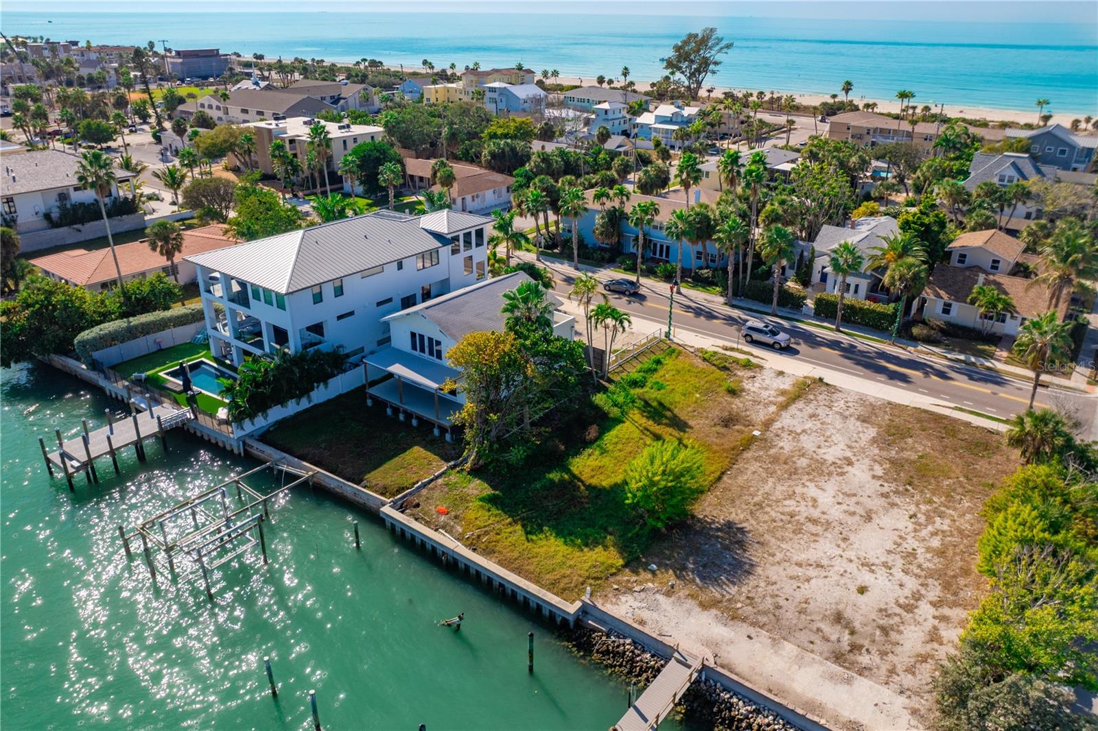 READY FOR CONSTRUCTION! Gorgeous lot on the Intracoastal Waterway in Pass-a-Grille, perfectly situated to enjoy sunrises and sunsets This prime lot is cleared and ready for a new construction home. There is an existing solid concrete seawall with plenty of space for a dock and lift. It is a short walk to pristine Pass-a-Grille Beach where you can enjoy miles of sugar sand beach alongside shimmering, clear blue waters. Catch fish right from your backyard! Pass-a-Grille is one of Florida's original, quaint beach communities complete with a gorgeous beach, amazing views of sunrises and sunsets, art, boutique shopping, delicious fresh seafood and casual dining, a laid back vibe and quick access to the Gulf for prime fishing grounds! Pass-a-Grille is a boater's, beach lover's and fisherman's paradise! This excellent location is only 20 minutes to colorful and lively downtown St. Pete and 30 minutes to Tampa International Airport. Your coastal dream home would be perfect here! This lot has a building permit for a gorgeous home with 4,463 sq. ft. air-conditioned (6,631 sq. ft. total) as well as an 829 sq. ft. pool - ask for plans and builder information if interested in seeing the permitted plan. Most likely, you'll want to design and build your own version of the waterfront lifestyle you've been dreaming of. Pass-a-Grille, with its storied history and original brick streets, is a beautiful place to land!