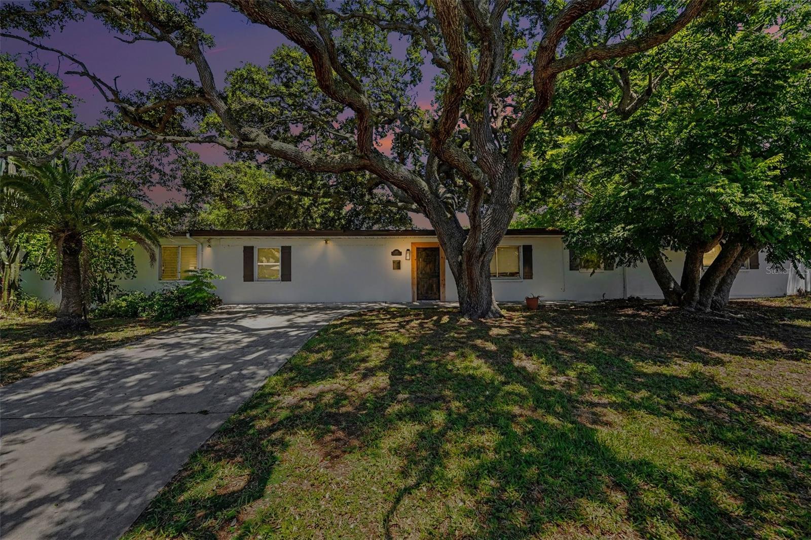 Virtually Staged. On one of Belleair's quiet, canopied streets, 217 Garden Circle has been thoughtfully renovated within the past several years, a four-bedroom, three-bath residence where light moves freely through open, gracious rooms.
The kitchen anchors daily life and entertaining alike: generous custom cabinetry, handsome countertops, and an oversized island that opens directly to the main living spaces, inviting conversation to spill from stovetop to sofa. Each finish feels considered, current, and calm.
The primary suite is a retreat unto itself, its renovated en-suite bath a private sanctuary at the close of the day. Three further bedrooms and two full baths flex easily, offering guest quarters, a study, room for a household to grow.
Beyond the walls, a wide, fully fenced lawn awaits: room to garden, to gather beneath the Florida sky, to shape the outdoor retreat you envision. Morning coffee here is unhurried. A built-in putting and chipping green invites friendly competition and gives you a place to fine-tune your short game without leaving home. A secluded side yard offers discreet, practical space, ideal for storing the boat, trailer, or seasonal equipment well out of view.
And the address itself is the rare kind. Belleair, home to world-class golf, storied country-club living, and tree-lined tranquility, places you minutes from the white sands of Clearwater and Belleair Beach, waterfront marinas, refined dining, and premier medical care, with Downtown St. Petersburg and Tampa International effortlessly within reach.
Private showings are available by appointment. Arrange your viewing of 217 Garden Circle today, and experience Belleair as few have the privilege to.