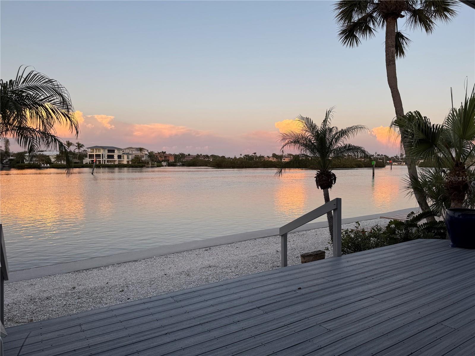 A $500K price reduction - don't wait! A rarely available bayfront opportunity to create your dream retreat on Siesta Key. Experience the allure of waterfront living in this detached bayfront villa, poised for a fresh vision in the desirable Polynesian Gardens community on Siesta Key. One of only 11 exclusive bayfront residences, this end-unit villa offers sweeping, unobstructed views of the Intracoastal Waterway from nearly every room, where sunrises paint the sky in breathtaking hues. Go outside to your expansive private waterfront deck, where you can unwind to the sights of boats gliding by, playful dolphins in the distance, and the peaceful rhythm of the bay. A natural beachfront at your doorstep invites you to dip your toes in the water and embrace the tranquil coastal lifestyle. Professionally remediated following Hurricane Helene, this residence is a blank canvas, ready for transformation. With a spacious two-bedroom, two-bath layout that exceeds the size of many three-bedroom villas in the community, the potential for a luxurious, customized retreat is limitless. Enjoy the privacy and convenience of your own garage and private entrance, delivering the feel of a single-family home, yet with the ease of villa living. The location is unbeatable, just minutes from the world-famous Siesta Beach, renowned for its soft quartz sands and mesmerizing Gulf waters, where mango-hued sunsets cap off each day. Centrally located on the island, you're moments from the vibrant dining, boutique shopping, and lively atmosphere of Siesta Key Village and South Siesta Village, and just a short drive to downtown Sarasota’s cultural arts scene, theaters, and fabulous dining. This is a rare opportunity to reimagine and create your custom bayfront sanctuary in one of Siesta Key’s sought-after communities. Don’t let this one-of-a-kind coastal gem slip away.