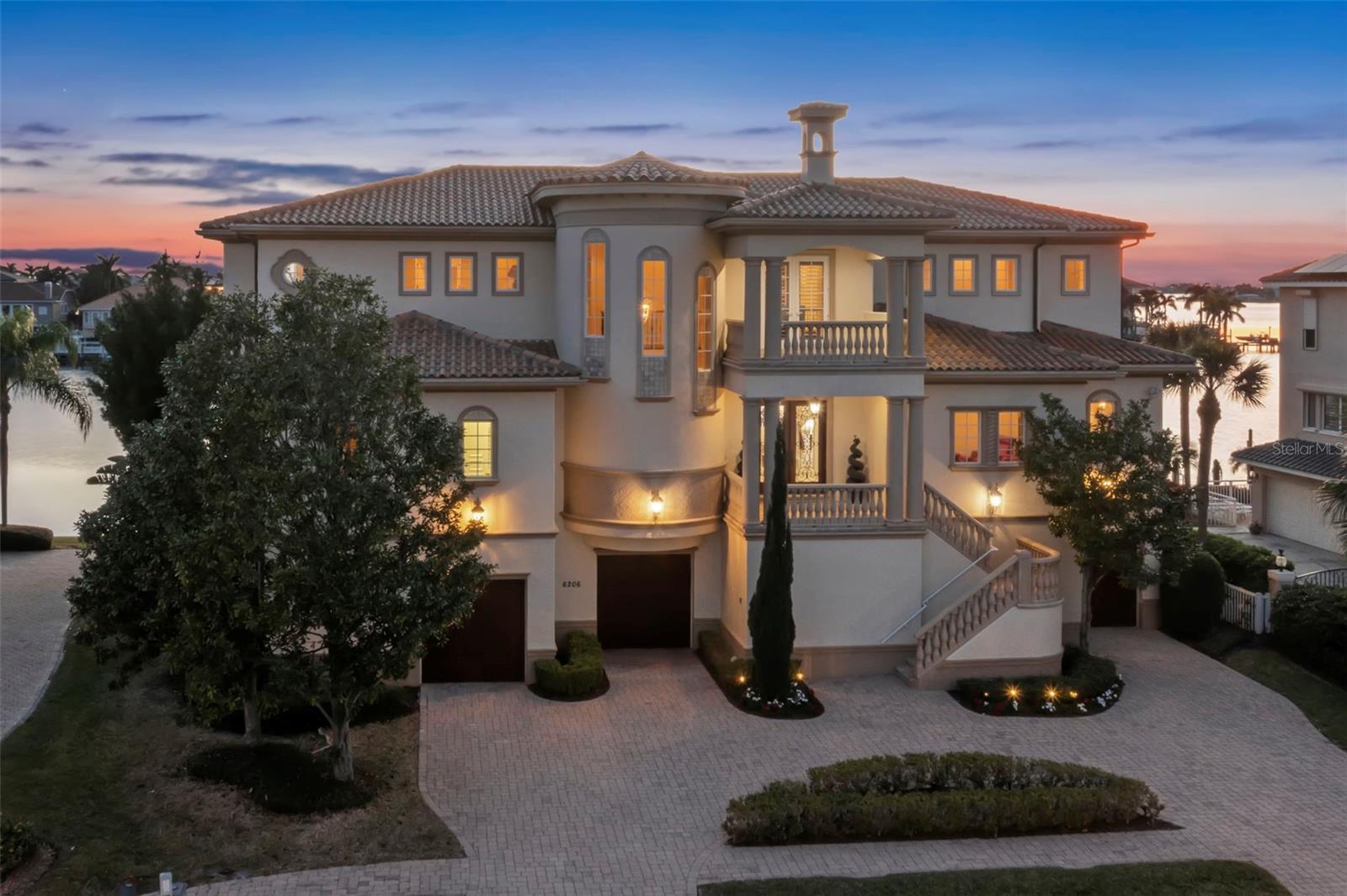 Introducing a Remarkable Waterfront Residence at an Unbeatable New Price. Discover the allure of this exceptional 5-bedroom, 5 1/2-bath waterfront masterpiece, meticulously crafted by Windstar Custom Homes and now presented at an amazing new price. Every aspect of this home reflects unparalleled artistry and unwavering attention to detail, tailored to meet the exacting standards of its discerning owner. Step inside to experience a seamless blend of top-quality materials and meticulous craftsmanship at every turn. This thoughtfully designed floor plan ensures that each family member enjoys the luxury of an en-suite bath, walk-in closets, and captivating water views. Spanning 5,545 heated square feet and a grand total of 10,785 square feet, this Spanish Mediterranean-style abode exudes timeless elegance and sophistication. Noteworthy stone and millwork, including 9 1/4-inch baseboards, 7 1/4-inch crown molding, and solid wood doors, create an atmosphere of refined luxury throughout the home. Situated on an extra-large lot with 107 feet of waterfront and a new seawall, this property offers ample space for a yacht and water toys, making it a truly unique opportunity. As you enter through the double mahogany front doors, you'll be greeted by breathtaking westward views in the formal living room, featuring cathedral ceilings, a cast stone gas fireplace, and floor-to-ceiling windows that frame the spectacular water vistas. The formal living and dining areas offer a front-row seat to unforgettable sunsets over Boca Ciega Bay, seamlessly blending stone floors with exquisite cherry hardwood. There is an office/study, adorned with mahogany cabinetry, a natural gas fireplace, and stunning coffered ceiling details, provides an ideal space for the family's CEO. The great room, incorporating a homework station, serves as the heart of entertainment. The culinary haven of the kitchen boasts custom cabinetry, a walk-in pantry, and top-of-the-line appliances, including a gas Wolf range, creating the perfect setting for hosting friends and family. The primary suite offers a luxurious sanctuary, complete with a cherry wood vestibule area, morning kitchen, and a dedicated workout/yoga room. The exquisite primary bath features a double-sided shower and a Jacuzzi tub, while a spacious covered deck off the master bedroom invites you to savor morning coffee while taking in magnificent views.

Outdoor living is equally impressive, with a fabulous pool, spa, and ample entertaining space on multiple covered expansive decks on all levels. Car enthusiasts will appreciate the incredible (3190 SQFT) garage, offering space for 5-plus vehicles and substantial storage. An elevator effortlessly connects all stories from the garage area, ensuring seamless access to every corner of this architectural masterpiece.

This exclusive club stands as the only gated, golf course, and truly waterfront community in the area. As an added bonus, the fortunate buyer of this home is offered the advantage of skipping the waitlist to join the highly sought-after Pasadena Yacht & Country Club. Don't miss this amazing buy and opportunity to make this exceptional waterfront residence your own.