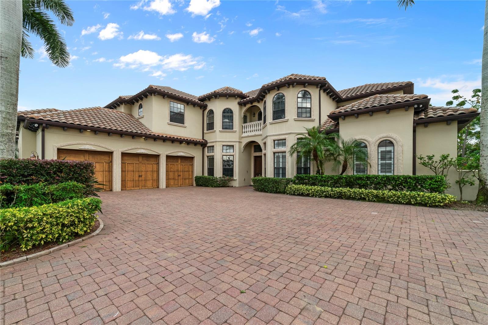 Under contract-accepting backup offers. Discover lakefront luxury living in this custom-built 5,528 square-foot Mediterranean estate, set on 1.8 acres along the shimmering waters of Lake Tibet—part of the world-renowned Butler Chain of Lakes. Nestled within Emerson Point, one of Bay Hill’s most distinguished and exclusive gated enclaves, this private sanctuary offers a rare blend of timeless elegance, serene natural beauty, and direct waterfront access with your own dock, boat deck, and lift. With six generously sized bedrooms, five full bathrooms, and half baths, this home was made for comfortable family living and unforgettable entertaining. From the moment you step through the grand double doors, you're welcomed by soaring coffered ceilings, a dramatic gas fireplace, and panoramic views of a quiet cove on Lake Tibet. The formal living room flows seamlessly into the heart of the home—a stunning gourmet kitchen featuring a center island, granite countertops, abundant storage, a breakfast bar, and appliances including double convection ovens and a DCS gas range. Whether hosting a dinner party or enjoying a quiet morning coffee, this kitchen elevates every moment. The first-floor primary suite is a true retreat, with peaceful lake views, custom closets, and a spa-inspired master bath complete with a luxurious dressing area. Entertain in style in the formal dining room, complete with a butler’s pantry. The custom office, media room, and versatile bonus room add flexibility to meet your lifestyle needs, while exquisite details like Travertine and hardwood floors, rich wainscoting, and high-end finishes create a timeless ambiance throughout. Step outside and experience resort-style living. A covered patio, sun deck, and lakeside pool with spa set the stage for relaxed afternoons and sunset gatherings. Fire up the outdoor grill and dine al fresco, all while taking in the tranquil beauty of the lake. A rare gem for nature lovers, the expansive backyard also features a self-sustaining mini farm—perfect for growing citrus, herbs, or your own garden-to-table vegetables. It’s a peaceful escape that brings sustainable living right to your doorstep, beautifully blending with the lakefront lifestyle. Recent upgrades include new AC units in 2023 and 2024, a 2023 tankless water heater, and the 2022 boat deck—making this home as efficient as it is elegant. Located just steps from the iconic Bay Hill Golf Club and offering community access to the Butler Chain of Lakes via Lake Chase, this home offers more than just a place to live—it’s a lifestyle. Enjoy scenic walks, world-class golf, fine dining along Restaurant Row, and upscale shopping—all just minutes away. Don’t miss this rare opportunity to own a true piece of paradise. Come experience the perfect balance of privacy, sophistication, and natural beauty in one of Orlando’s most desirable lakefront communities.