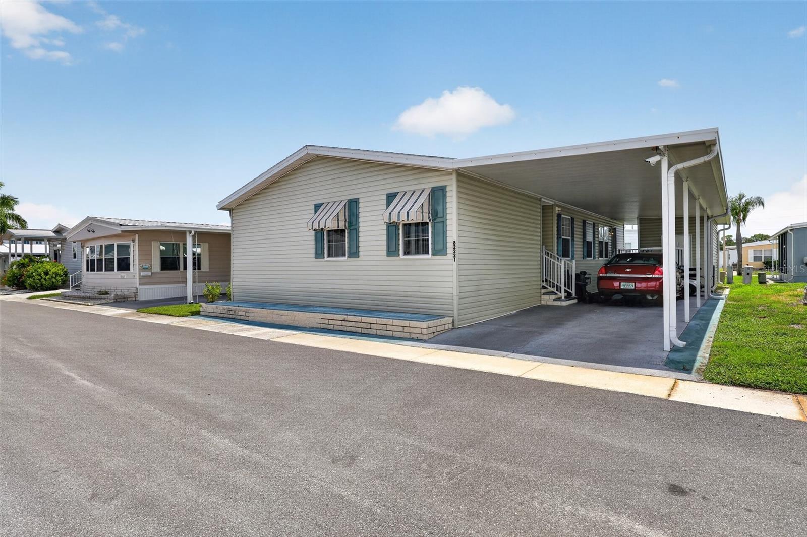 Rare 3-Bedroom Gem in Premier 55+ Co-Op Community!

Welcome home to this beautifully maintained, 2004-built manufactured home offering a rare and highly sought-after 3-bedroom, 2-bathroom split floor plan. Spanning a spacious 1,404 square feet, this home feels incredibly open and airy thanks to impressive vaulted ceilings throughout.

Rest easy knowing the big-ticket items are already taken care of, including a new roof (2021), new hot water heater (2026),  This partially furnished home, is waiting for new owners the fully equipped kitchen has a breakfast bar and  a new stainless steel Refrigerator (2025). Located off of the Kitchen, behind the glass panel door is where convenience is key with a dedicated indoor laundry room complete with a washer and dryer.  The owner's en suite is equipped with a double vanity and a garden tub. All bedrooms are of great size. with walk in closets for all of your storage needs The guest bathroom is of ample size with a walk in shower.  Stylish new exterior fabric canvas awnings (2024) that add fantastic curb appeal. The oversized carport comfortably accommodates two vehicles and features a sleek epoxy finish. Love to tinker? You’ll appreciate the exterior utility building, perfect for a workshop or extra storage. This golf cart community offers it all . Some residents drive their cart to one of the local  courses Mainlands Golf Club 

Located in a highly desirable 2026 Award winning  co-op community where you own the land, you'll enjoy a vibrant, active lifestyle with access to a sparkling pool, shuffleboard, and tennis courts. Best of all, you are perfectly situated right off Route 19—just minutes from the best shopping, dining, and stunning Gulf beaches in the Pinellas Park and St. Petersburg area.