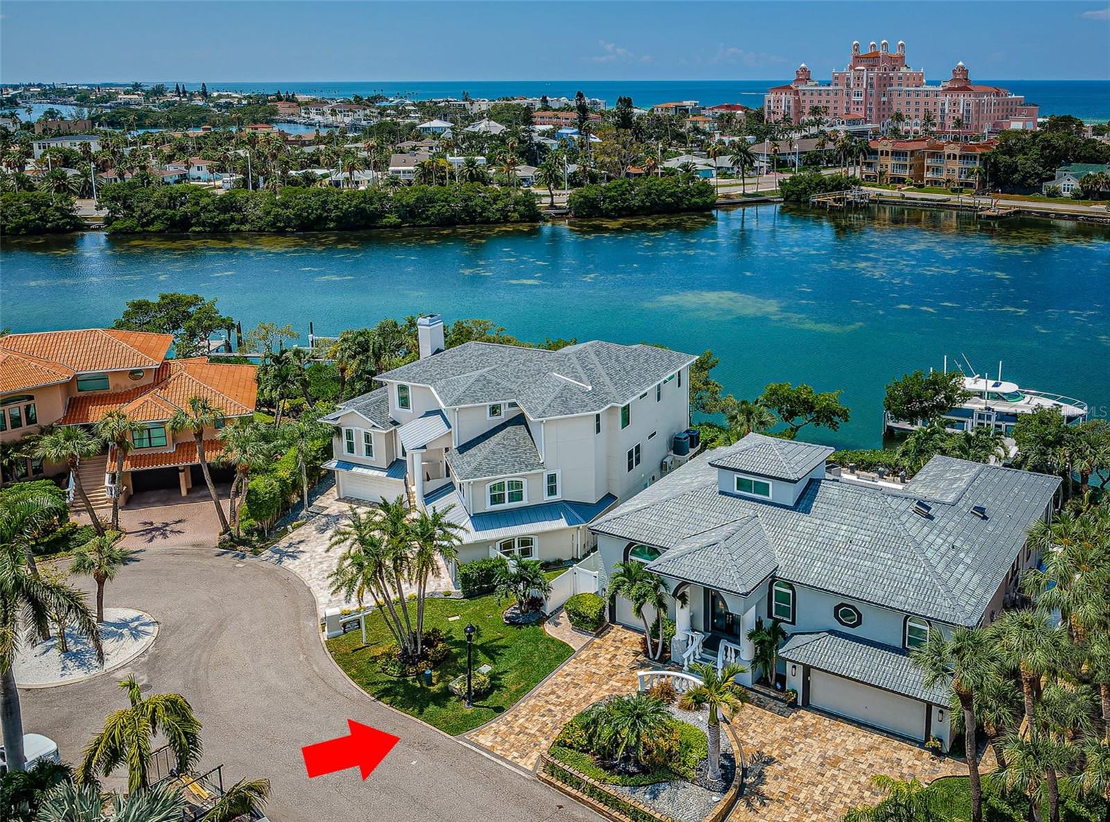 THE STANDARD BY WHICH MODERN LUXURY WATERFRONT LIVING IS TO BE JUDGED! With spectacular views of the Don Cesar in its foreground, this resplendent coastal contemporary residence is the architype of the 21st century Florida waterfront home. Elegant, highly functional and beautifully efficient, welcome to lavish home that leaves nothing to want. Expertly installed brick pavers and lovely complementary landscaping transition to a fine covered double-door entry with tall columns and cast-stone handrails/balusters. Inside, you’ll discover an inspiring, open, coastal-contemporary ambiance with high ceilings, eye-catching light fixtures, fabulous “driftwood” porcelain floors and superb views of the waterfront. The impressive great room enjoys a stunningly-tiled entertainment wall with built-in audio/visual and unique ethanol-burning fireplace, and access to a large, luxury waterfront deck overlooking the “Don.” The brilliant kitchen boasts coastal-white shaker-style cabinetry, beautiful counter surfaces with striking backsplash, Subzero and Wolf stainless steel appliances, a center island with cooktop, built-in beverage center with buffet and a sizable breakfast bar. Your dramatic formal dining room is offset by a terrific casual dining/sitting area with wide views of the water. A remarkable owner’s suite features posh, avantgarde appointments, an astonishing leading-edge custom closet system, and access to a splendid private owner’s balcony with commanding views of the pool deck and waterway. The sumptuous owner’s bath is dazzling in every way; extraordinary materials and craftmanship are combined thoughtfully and purposefully to deliver a deeply satisfying human experience. Ideal for dining and entertaining, your main balcony deck leads to a fabulously landscaped waterfront oasis with a grand lower-level covered deck, gorgeous pavers, an inviting custom-trimmed Pebbletec pool, numerous sitting areas, and so much more. Step out to the wonderfully illuminated composite dock and it’s astounding 40,000lb yacht lift, and a secondary boat lift – providing rapid access to the Gulf of Mexico. With easy access to Tampa and downtown St. Pete, and updates and upgrade too numerous to mention here, this amazing home is an outstanding luxury waterfront value! Recognized as one of America’s best beaches, St. Pete Beach offers exceptional dining, shopping and entertainment. A great location to live, work and play. Dimensions are estimates, buyer to verify. There is a $650.00  Assumable Flood Policy.