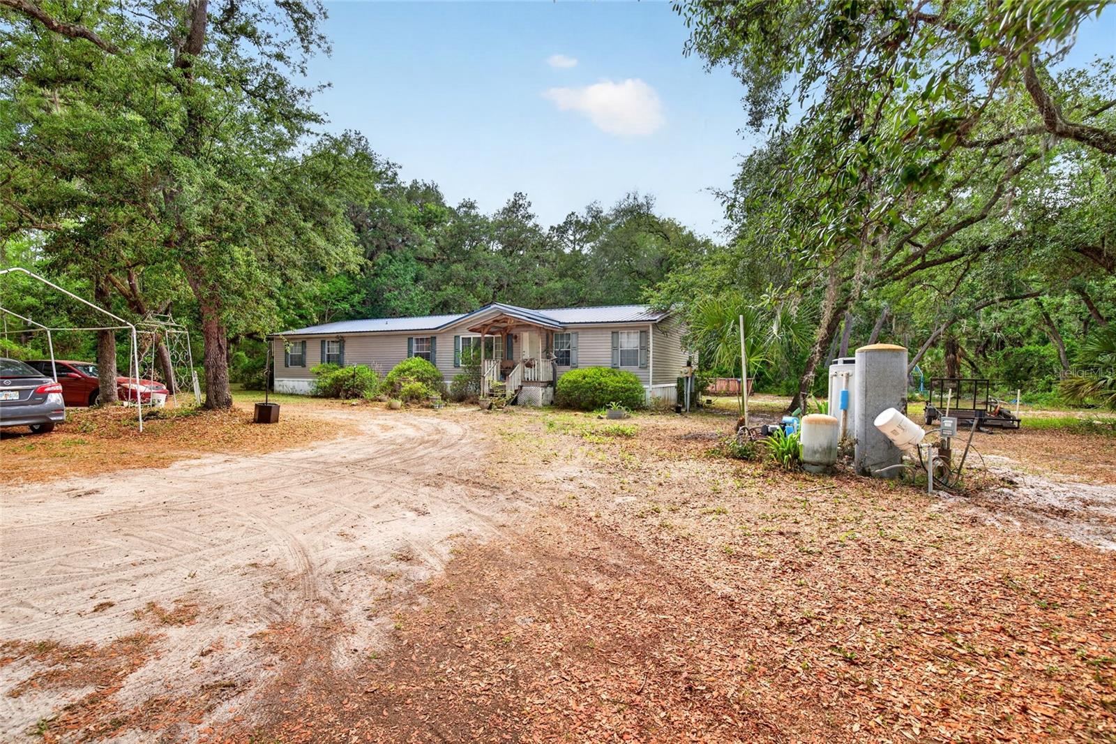 RARE FIND!   5 bed 3 bath home with solid plywood floors throughout!   Enjoy minimal neighbors as your property backs up to the GREENWAY & over 444 acres of FOREST!!    METAL ROOF 2014-- Fenced on 3 sides fence. Horse pasture/dog run.   Large wooden porch in back.  Shed for storage, 24 ft round 48 tall above ground pool with pump.  Chicken coop.  Wood burning Fire place . .