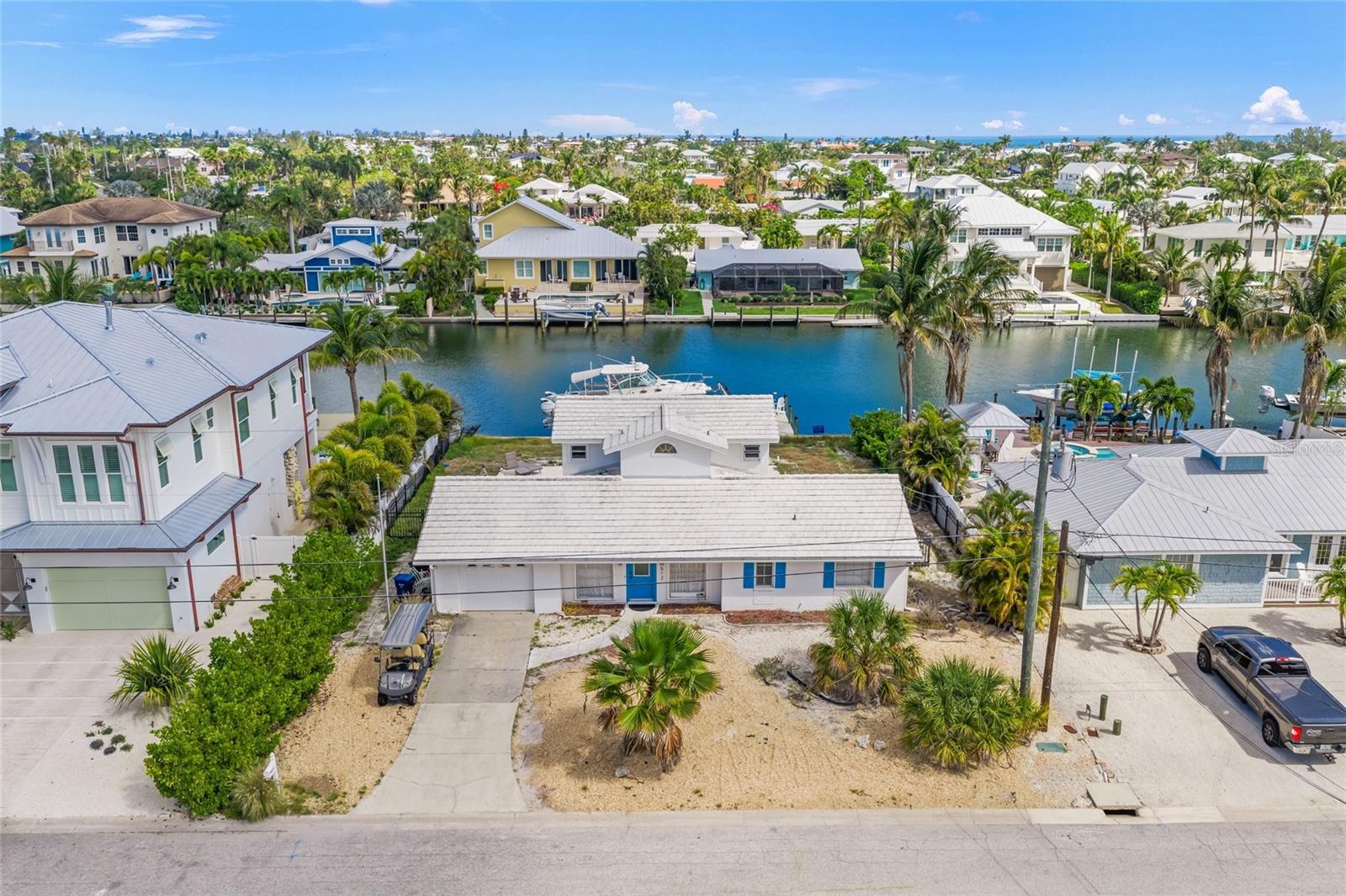 This oversized lot features an expansive seawall, a brand-new dock, and a 16,000-pound boat lift, offering endless possibilities to build your custom dream home or renovate the existing residence to fit your lifestyle. Enjoy the outdoor Florida lifestyle with a large built-in pool and spa, complete with a new heater. Situated on one of the widest canals in Holmes Beach, this property provides easy boating access through Bimini Bay and directly out to the open waters of the Bay. A rare waterfront gem that truly must be seen to be appreciated!