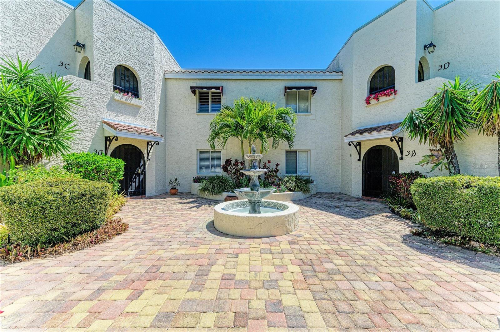 Opportunities to own the largest floor plan in Vizcaya are exceptionally rare, as this 3-bedroom "Azalea" model marks the first time a residence of this scale has reached the market in several years. While smaller units appear periodically, this specific 3-bedroom, 3-bathroom configuration is the most elusive footprint in the community, offering a level of utility and privacy that hasn't been available to buyers in years. Situated on the second floor, this pristine condo features high ceilings and a light-filled, open layout highlighted by a screened front entrance with double doors and a large, glass-enclosed Florida room providing quiet garden and water views. The interior is designed for comfort and functionality, offering a double master suite and dual walk-in closets, while every bedroom in the floor plan enjoys its own private balcony access. Notable improvements include beautifully updated kitchen and bathrooms. This home also provides dual views—overlooking the IMG Golf Course from the front and tranquil fountains from the rear—along with a versatile third bedroom perfect for an office, a full-sized laundry room with extra storage, and a private carport. Located in the gated, Mediterranean-style enclave of Vizcaya, residents enjoy luxury amenities including an Olympic-sized heated pool, spa, and fitness center, all just minutes from IMG Academy and the gulf beaches of Anna Maria Island. Given that a 3-bedroom unit of this caliber has not been available for years, this is a fleeting opportunity in the El Conquistador area.