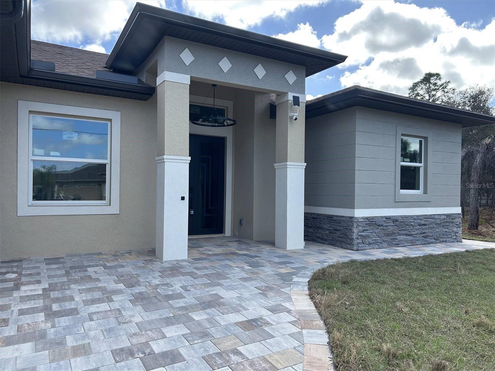 Welcome to this beautifully crafted new construction home in North Port, just completed in 2026 and ready for its very first owner. Designed with comfort, style, and modern Florida living in mind, this custom-built residence combines elegant finishes, an open layout, and thoughtful upgrades throughout. 

From the moment you arrive, the home stands out with its expansive driveway, spacious 3-car garage, and paver walkways that wrap around the property. Step inside and you'll immediately notice the bright, open feel created by 10-foot ceilings, 8-foot doors, crown molding, and quality laminate flooring throughout the home.

The heart of the home is the oversized chef’s kitchen, designed for both entertaining and everyday living. It features upgraded cabinetry, stainless steel appliances, a built-in oven and microwave combo, beverage fridge, and generous counter space with a large island that opens seamlessly to the main living area.

The spacious primary suite offers a relaxing retreat with a luxury bathroom featuring dual sinks, a walk-in shower, and a freestanding soaking tub. Two additional bedrooms and full bathrooms provide flexible space for guests, family, or a home office.

Enjoy true Florida indoor-outdoor living with the large covered lanai and extended patio, ideal for morning coffee, weekend gatherings, or simply relaxing outdoors. The home also includes an outdoor kitchen hookup and exterior shower, making it easy to create the perfect backyard entertaining space.

Built for both comfort and peace of mind, the home includes hurricane-impact windows and doors, modern remote-controlled lighting fixtures, and numerous custom upgrades that elevate the overall design.

Located on a 10,000 sq ft lot in North Port, this home offers easy access to shopping, restaurants, parks, schools, and the Gulf Coast’s beautiful beaches while still providing the space and privacy of a residential neighborhood. 

Why wait for new construction when this brand-new home is finished and move-in ready? Schedule your showing today and experience the quality and design for yourself.