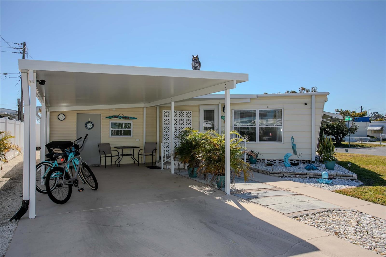 Location, location, location! This land-owned 55+ corner-lot home sits directly across from the community pool and peaceful pond, giving you one of the best spots in the neighborhood with a relaxing view right from your front patio. Perfect for seasonal or year-round living, this light and bright 2-bedroom, 2-bath home offers an affordable, low-maintenance Florida lifestyle just minutes from the world-famous beaches of Anna Maria Island.

Enjoy peace of mind with major updates already done for you: new roof, new carport, a newer central A/C (2020), newer water heater and updated bathrooms. The spacious bedroom layout easily accommodates king-size beds in both bedrooms and the home includes a full-size stack washer and dryer plus all kitchen appliances—truly move-in ready so you can start enjoying the Florida sun from day one.

This pet-friendly 55+ community is land-owned (no lot rent) and features a low monthly fee of just $135, which helps keep your carrying costs down while you enjoy the amenities. Meet neighbors and stay active at the community pool, clubhouse with organized activities and shuffleboard courts—there’s always something to do and someone to do it with. With a prime corner location, great updates, and an unbeatable price point, this home is an excellent opportunity for buyers looking to lock in an affordable Florida lifestyle close to the beaches, shopping and entertainment. Come see why so many people are choosing to call this community home—schedule your private showing today!