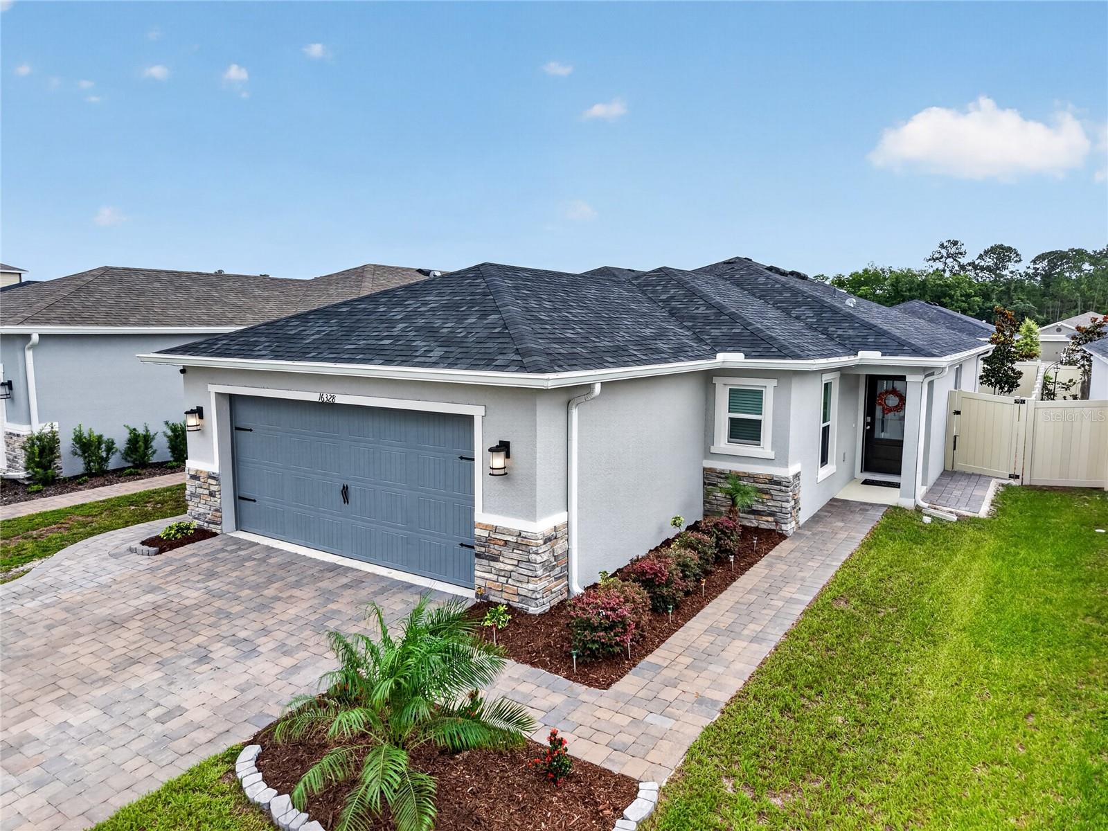 Why Wait to Build When This Home Has It All?Welcome to this stunning 3-bedroom, 2-bathroom home in Clermont, Florida — where premium upgrades, thoughtful design, and an unbeatable location come together to deliver the lifestyle you've been waiting for.From the moment you arrive, you'll notice the difference. The widened driveway — extended an additional three feet — is beautifully framed by paver extensions on both sides of the home, creating outstanding curb appeal. Step inside and be greeted by luxury vinyl plank flooring throughout, offering a seamless, upscale feel from room to room.The primary suite is a true retreat, featuring a tray ceiling, spacious walk-in closet, and an elegant finish that feels anything but builder-basic. Plantation shutters add a classic, polished touch to every window, while gutters and a fully fenced yard give you the privacy and peace of mind you deserve.The garage is equally impressive — complete with a Shark Coat epoxy floor, a built-in whole-home surge protector, and an EV charging station ready for your electric vehicle. Smart living is built right in with a smart thermostat and smart refrigerator, keeping your home connected and efficient.Location? Absolutely unmatched. Clermont puts you just minutes from Walt Disney World, Universal Studios, and within easy reach of Florida's gorgeous beaches — making this home as ideal for full-time living as it is for those seeking a vacation or investment property.Every upgrade has already been done — just move in and enjoy. Homes like this don't last long.Schedule your private showing today!