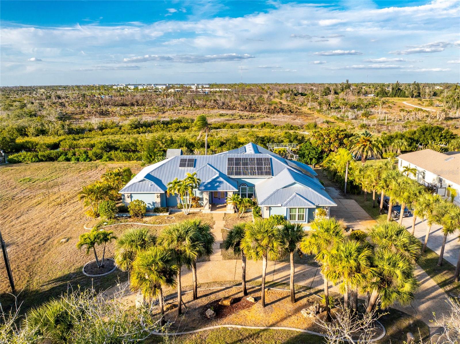 WHERE ELSE CAN YOU FIND A WATERFRONT HOUSE THAT BACKS UP TO A STATE PARK???? Don’t let this opportunity pass you by. Welcome to a rare waterfront, no-bridges-to-the-Bay home backing directly onto Don Pedro Land Base State Park. This stunning 4-bedroom, 3-bath, 2-car garage pool home delivers the ultimate Florida lifestyle, and with a NEW POOL CAGE COMING SOON, it's an even better choice! 

Offering over 3,500 square feet of living space, the spacious open floor plan provides room for everyone and is designed to seamlessly blend indoor and outdoor living. Multiple IMPACT RESISTANT sliding glass doors open to expansive outdoor areas, creating the perfect setting for entertaining or simply enjoying the surrounding natural beauty.

The updated kitchen features granite countertops, pendant lighting, a double wall oven, Sub-Zero refrigerator, breakfast bar, and a cozy breakfast nook. Just off the kitchen, enjoy a dry bar with a 100+-bottle wine cooler, ideal for hosting guests.

The primary suite is a true retreat, featuring two sets of sliders leading to the lanai, a large walk-in closet, and a double-sided decorative fireplace for added ambiance. The luxurious primary bath includes an updated vanity w/solid surface countertop and double basins, updated walk-in shower, Privacy commode and a Jacuzzi tub. Bedrooms two and three share a Jack and Jill Guest Bath #2 (with vanity w/double basins and private toilet/combo tub/shower area) on the opposite side of the home, while the fourth bedroom, located adjacent to the primary suite, makes an excellent office or den. Guest Bath #3 also serves as the pool bath and features a new vanity w/solid surface countertop, new mirror, linen closet and combo tub/shower. 

SOLAR PHOTOVOLTAIC SYSTEM has provided the current owner with EXTREMELY LOW ELECTRIC BILLS all year round! This is an OWNED OUTRIGHT SYSTEM!

Additional features include travertine flooring throughout, all IMPACT DOORS AND WINDOWS for your peace of mind and a big insurance credit, metal roof new in 2020, and three-zone central heating and air for energy efficiency,(two of them were new in 2021) plus two mini splits (new in 2020) in Guest bedrooms 2 & 3. Outdoors, the pool and spa provide the perfect place to relax, cool off, or exercise, while the expansive deck is ideal for enjoying Florida’s sunshine. A pathway leads to a private dock with a 6,000-pound boat lift, offering immediate access to miles of incredible waterways.

Privacy and tranquility are assured with protected state park wetlands directly behind the home. Enjoy daily wildlife sightings including eagles, ospreys, water birds, otters, and manatees. A private beach is also available with association membership.

If you love nature, boating, and waterfront living, this truly one-of-a-kind offering is ready to be called home. Call today to schedule your private showing.
