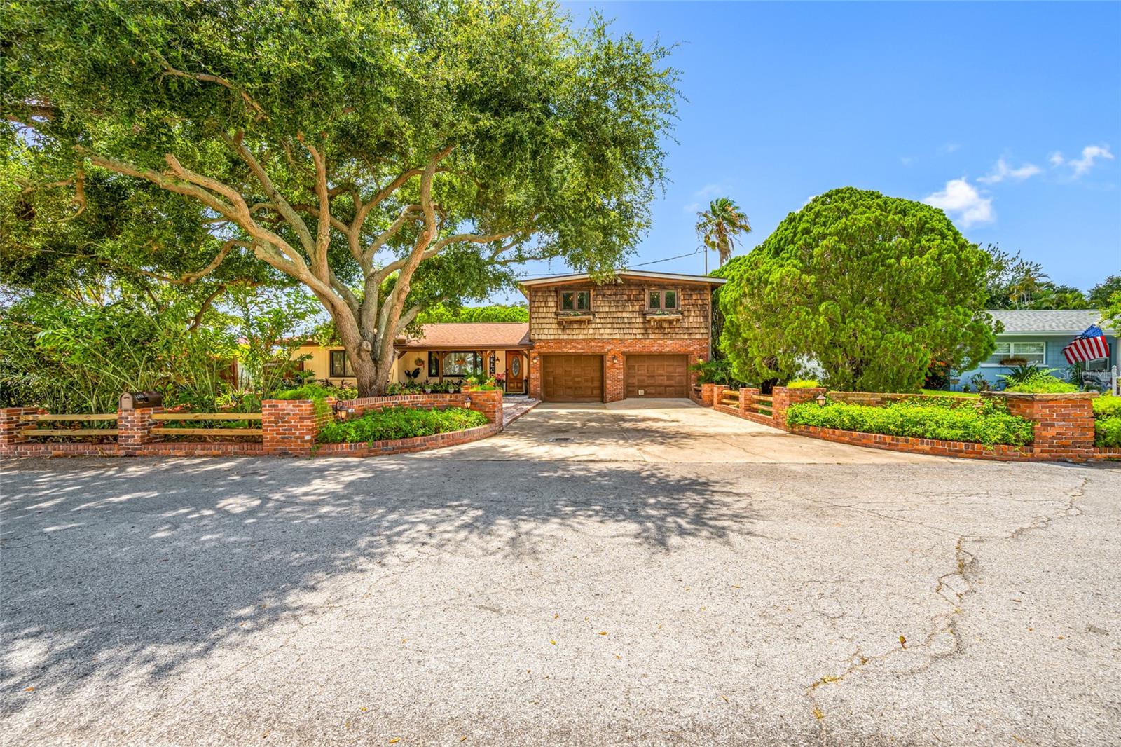 Presented is a unique opportunity to own a special home in the heart of Clearwater, Florida. Unincorporated zoning, currently operating as a short term rental, and listed at appraisal. This home has character and meticulous craftsmanship. The 4-bedroom + office (easily convertible to a 5th bedroom), 3-bath BLOCK pool home features exquisite custom woodworking throughout, TWO gas fireplaces, an extended family room, solar tubes for additional natural light, a 36" commercial stove in the kitchen, and a custom built-in bar perfect for entertaining. The backyard features a fiberglass pool, no maintenance turf, a large metal gazebo, covered patio with a deck for outdoor dining, it is a serene and dream backyard. Surrounded by mature trees for shade and vinyl fence all around the property. Creatively landscaped with botanical flowers and tropical palm trees in the park. The oversized second bay in the 2-car garage provides extra storage or workshop space. The primary suite is conveniently located downstairs with a walk-in closet, while three additional bedrooms are upstairs, featuring newer luxury vinyl plank (LVP) flooring. The home also includes a first-level office and laundry room with wash sink and shower. Major updates include: Newer roof (2024), newer AC (2024), tankless gas water heater (2025), and septic serviced/emptied (2026). This centrally located property offers space, flexibility, and timeless charm. The nearby Duke Energy Trail is great for biking and this home is zoned for schools with high ratings. It is centrally located near shopping, dining, airports, Tampa bridges, and Clearwater’s world-famous beaches. Don't miss the chance to see this beautiful unique home.Don't miss the chance to see this beautiful unique home.