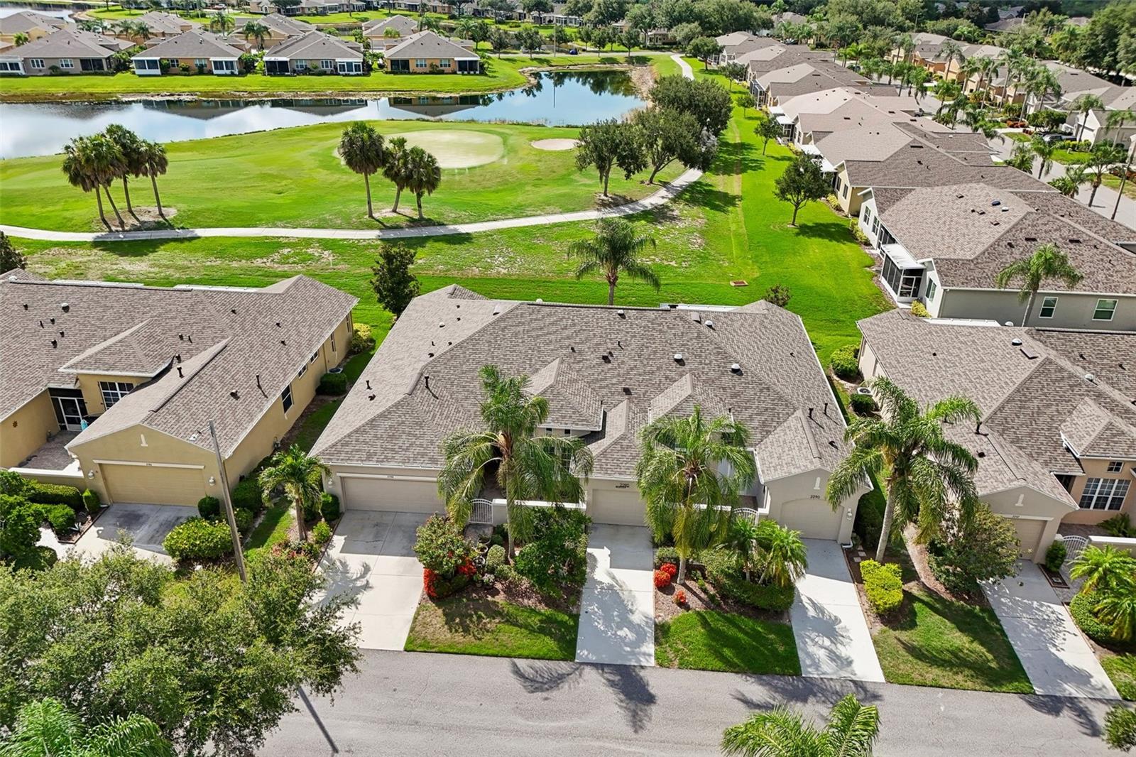 Welcome to your dream golf course retreat in the highly desirable Maplewood neighborhood of Kings Point, a premier active-adult community in Sun City Center. Boasting mature landscaping, a spacious two-car garage, a front open porch, and a welcoming covered entry, this beautiful three-bedroom, two-bathroom condo offers the peaceful privacy of having only one shared roof mate. As you step inside, soaring tall ceilings immediately elevate the living space, creating a grand, airy ambiance that flows naturally toward the back of the home.
The heart of the residence is designed for seamless entertaining and comfortable daily living. A breakfast bar overlooks the kitchen, which features rich wood cabinets with elegant glass display doors, stainless steel appliances, and plenty of prep space. The main living and dining areas open up to a versatile bonus room, offering the perfect spot for a cozy reading nook, a sun-drenched library, or a private home office with scenic patio views. Sliding glass doors lead from the main living area out to the screened-in back patio, seamlessly connecting indoor comfort to your own private oasis where you can relax and take in the lush, mature landscaping and serene golf course views.
The private primary suite serves as a true sanctuary, complete with a spacious bedroom and an en suite bathroom featuring dual sinks, a deep soaking tub, and a separate walk-in shower. Two additional generously sized guest bedrooms provide plenty of space for family, visitors, or hobbies, sharing a second full bathroom equipped with a classic shower/tub combination.
You’ll love Sun City Center with its amazing facilities, pools, and clubs just waiting for you to enjoy. Nestled between Sarasota and Tampa, this location offers a convenient ride to airports, great shopping, dining, and professional entertainment. With easy access to award-winning, sandy beaches, this home provides the best of all worlds without the stress of big city life. Leave it all behind and enjoy your new life here in one of Florida’s most affordable 55-and-better communities!
