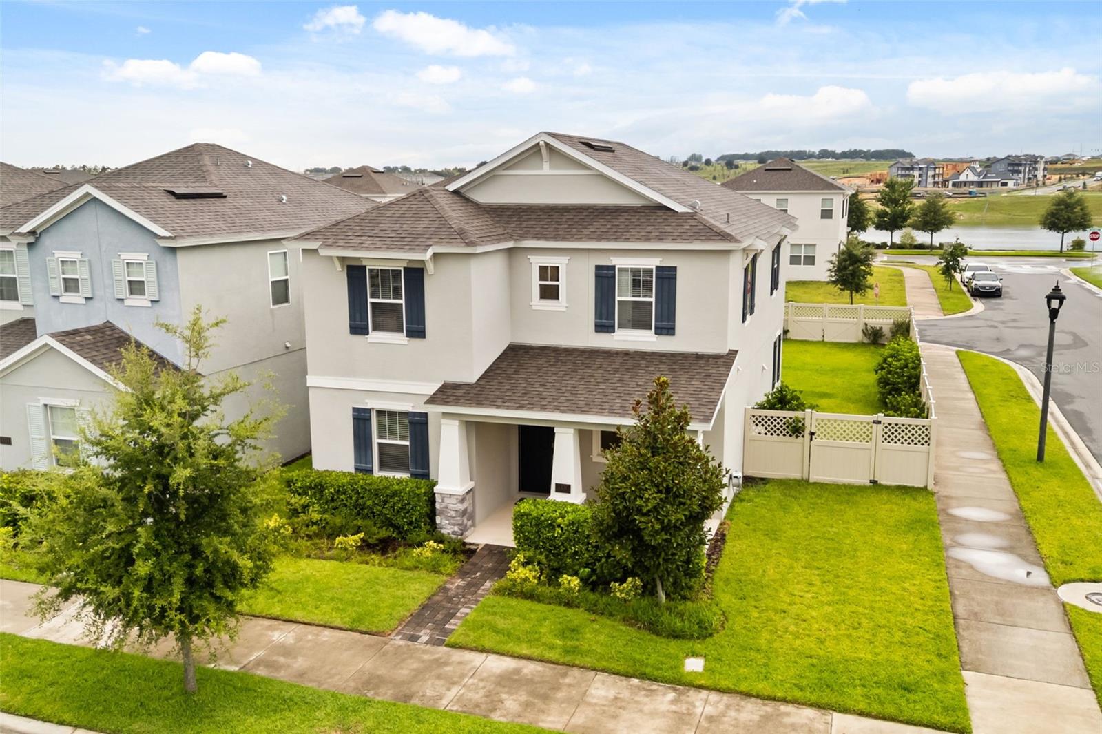 Welcome to this beautifully appointed corner-lot home featuring a desirable rear-load garage and a convenient first-floor guest suite, perfect for multi-generational living or visiting guests. Offering approximately 2,500 square feet of thoughtfully designed living space, this 4-bedroom, 3.5-bath residence combines modern elegance with everyday comfort.

Step inside to discover soaring 10-foot ceilings, abundant natural light, and an expansive open-concept floor plan designed for effortless living and entertaining. At the heart of the home is a stunning gourmet kitchen featuring stainless steel appliances, 42-inch white cabinetry, quartz countertops, and an oversized island with generous prep and gathering space.

The spacious covered lanai opens to a large backyard with plenty of room to add your dream pool, creating the perfect setting for outdoor dining, entertaining, or simply enjoying Florida's year-round sunshine. A private fenced courtyard-style lawn adds even more outdoor living space for family, pets, or relaxing evenings.

Upstairs, you'll find three additional bedrooms, including the luxurious primary suite. Designed as a peaceful retreat, the spa-inspired ensuite features a soaking tub, subway-tiled walk-in shower, dual quartz vanities, and a spacious walk-in closet.

Impeccably maintained and move-in ready, this exceptional home is ideally located just minutes from Hamlin Town Center, Winter Garden Village, top-rated schools, FL-429, and Walt Disney World, offering the perfect blend of convenience and lifestyle.

Situated in the heart of Horizon West, one of the nation's fastest-growing master-planned communities, Lakeside at Hamlin places you just steps from the future Life Time Athletic Country Club—an approximately 80,000-square-foot luxury wellness destination featuring resort-style pools, lap pools, pickleball and sports courts, a full-service spa, and state-of-the-art fitness facilities.

Don't miss the opportunity to make this exceptional home yours. Schedule your private showing today!