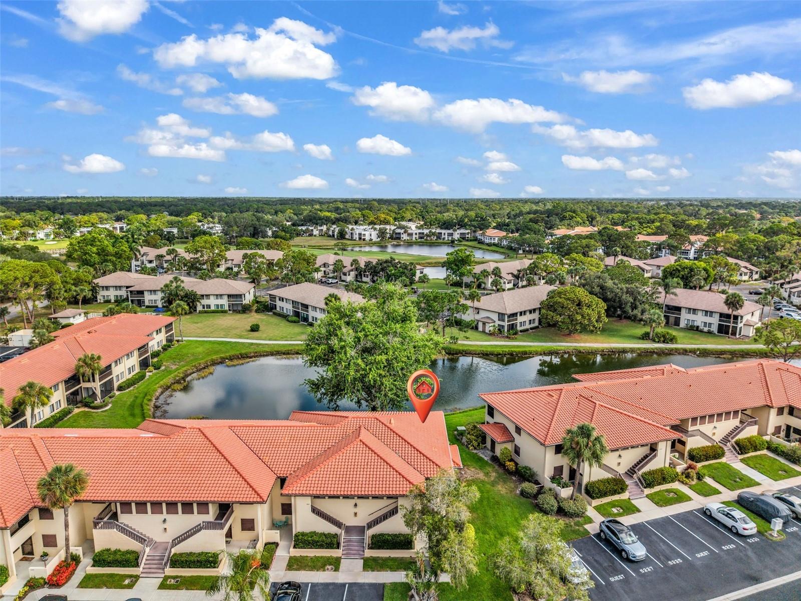Imagine starting every morning with peaceful lake views, gentle breezes, and the tranquility of waterfront living right from your own screened lanai. Nestled in the desirable Lake Village community, this beautifully maintained condo offers the perfect blend of comfort, convenience, and the relaxed Sarasota lifestyle buyers are searching for. Step inside to discover a spacious, light-filled floor plan designed for easy living and effortless entertaining. The expansive living and dining areas flow seamlessly together, creating an inviting space for gathering with family and friends while large sliding glass doors frame the stunning water views beyond. The oversized screened lanai feels like an extension of the home, providing the perfect place to enjoy your morning coffee, unwind after a day of shopping or exploring Sarasota, or simply soak in the serene lakefront setting. The kitchen offers abundant cabinetry, generous counter space, and a cozy breakfast nook, making meal preparation both convenient and enjoyable. The thoughtful split-bedroom layout provides privacy for everyone, with a spacious primary suite that serves as a peaceful retreat featuring ample closet space and an en-suite bath. The guest bedroom is generously sized and ideal for visiting family, friends, or a home office. Beyond the home itself, the location is truly hard to beat. Just minutes from The Mall at University Town Center, you'll have access to some of Sarasota's best shopping, dining, entertainment, and everyday conveniences. Whole Foods, Fresh Market, Benderson Park, countless restaurants, golf courses, medical facilities, and downtown Sarasota are all within easy reach. Spend your mornings shopping at UTC, your afternoons exploring St. Armands Circle, and your evenings enjoying dinner downtown before returning home to the peaceful setting of your lakeside retreat. Whether you're looking for a full-time residence, seasonal getaway, or investment opportunity, this condo delivers the maintenance-free Florida lifestyle buyers want in one of Sarasota's most convenient and sought-after locations. With beautiful water views, generous living space, and easy access to Sarasota's top destinations, this is an opportunity you won't want to miss.