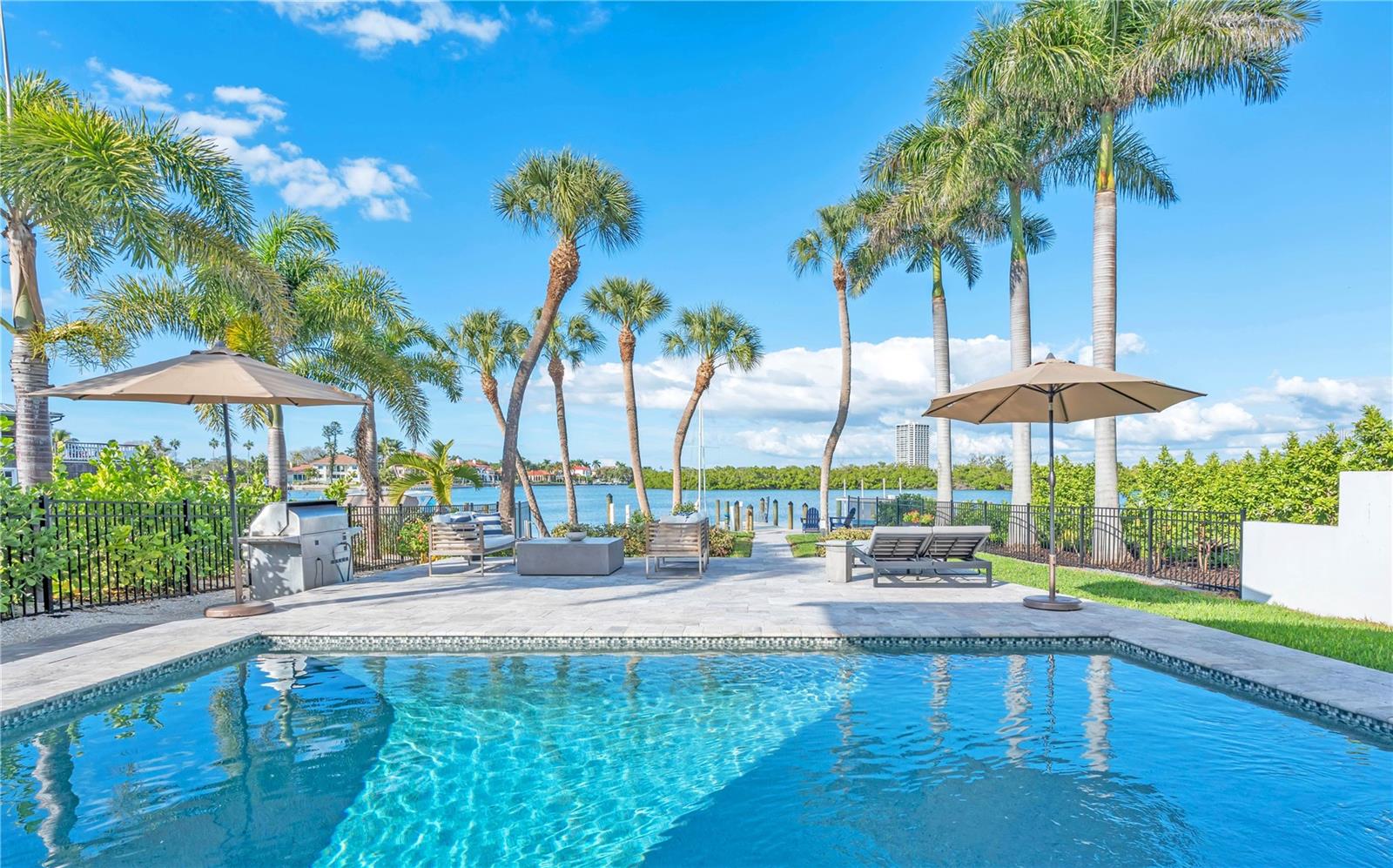 An Exquisite Bayfront Residence on Prestigious Lido Key, Sarasota. This meticulously reimagined two-story bayfront masterpiece embodies the pinnacle of sophisticated coastal living. Offering 3,832 square feet of thoughtfully designed interior space which was fully renovated in 2017, including impact-resistant doors and windows and a new roof. The residence features 4 ensuite bedrooms, a state-of-the-art 2025 gourmet kitchen, designed for discerning entertainers, showcases premium appliances, custom cabinetry, and an expansive island that serves as the heart of the open-plan living areas. The new elegant flooring unifies the bright, voluminous interiors. The second story includes a spacious home office with views over the pool to the bay. Beyond the interiors lies a private waterfront sanctuary: a heated saltwater pool overlooks an expansive floating dock, ideally suited for vessels of varying sizes, kayaks, or paddleboards. Unobstructed sailboat access invites effortless exploration of the bay and beyond. Additional conveniences include a spacious two-car garage, proximity to downtown Sarasota's vibrant cultural scene, a 15-minute drive to Sarasota-Bradenton International Airport. Close by is the pristine sands of Lido Beach with the most spectacular sunsets and moments away is St. Armands Circle's dining and shopping. Framed by the preserved mangroves of Otter Key, the sheltered waters host an abundance of marine life, dolphins, manatees, and graceful wading birds frequently enchant residents with their presence. This extraordinary property represents a rare harmony of tranquil waterfront serenity, impeccable modern enhancements, and unparalleled proximity to Sarasota's finest amenities—an enduring legacy of refined coastal elegance. Independently certified appraisal on 03/05/2026 by Birkholz Appraisal Group: Value by sales comparison approach $5.9M and Value by cost approach $6.2M