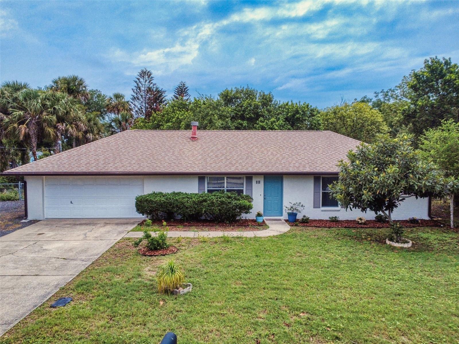 This well-built move in ready concrete block home has been recently updated with beautiful new kitchen cabinets and stunning quartz countertops and is located in a highly desirable Riverside neighborhood, offering easy access to the scenic Riverside Drive walking and biking path, nearby parks, marinas and grocery shopping. The bathrooms have updated vanities,quartz counter tops, toilets and showers and the exterior of the home has been freshly painted. 
Just 10 minutes from New Smyrna Beach via either causeway, you’ll enjoy quick access to top dining, entertainment, and local events.
Situated on a fully fenced 1/3-acre lot with two gated entrances, the property offers both privacy and convenience. Step out from the kitchen onto a spacious patio—perfect for outdoor dining or relaxing in a shaded, garden-like setting.
Additional features include a dedicated space to park and hookup your RV and an attached oversized two-car garage with ample space for vehicles, storage, laundry, or even a workshop. Roof (2018) A/C (2023) Water Heater (2024)