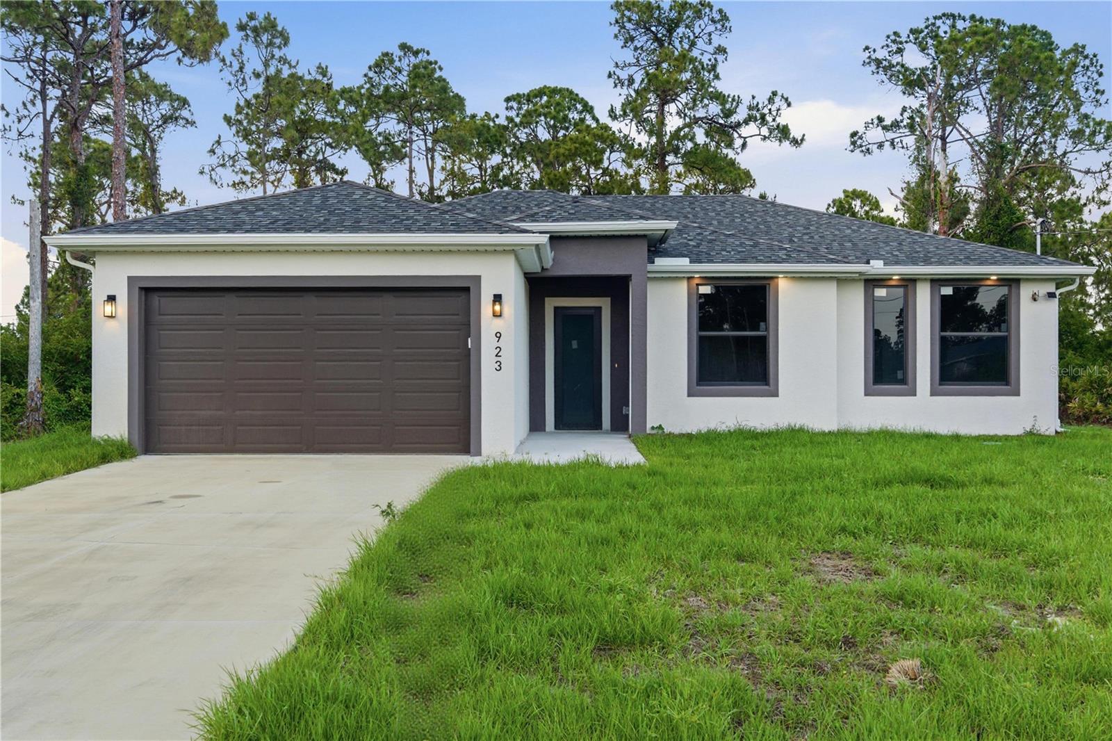 Welcome to this stunning new construction home in the growing community of Lehigh Acres! Completed in 2026, this beautifully designed 3-bedroom, 2-bathroom residence offers the perfect blend of modern style, comfort, and functionality.

Step inside and be impressed by the bright open-concept layout, soaring ceilings, and elegant finishes throughout. The gourmet kitchen is the heart of the home, featuring sleek high-gloss cabinetry extending to the ceiling, quartz countertops, a stylish subway tile backsplash, stainless steel appliances, and plenty of space for cooking and entertaining.

The spacious primary suite offers a relaxing retreat, complete with a beautifully appointed bathroom featuring dual vanities with quartz countertops and designer arched mirrors that add a touch of sophistication. Thoughtfully designed with quality craftsmanship and attention to detail, this home is truly move-in ready.

Enjoy the convenience of a 2-car garage, an oversized driveway, and a generous lot surrounded by Florida's natural beauty. Ideally located approximately 25–30 minutes from Fort Myers and 50–60 minutes from Naples, you'll have easy access to Gulf Coast beaches, shopping, dining, entertainment, schools, parks, and major roadways.

Whether you're a first-time homebuyer, seasonal resident, or investor, this exceptional property offers incredible value and modern living in one of Southwest Florida's fastest-growing areas.

Schedule your private showing today and discover everything this beautiful new home has to give you!