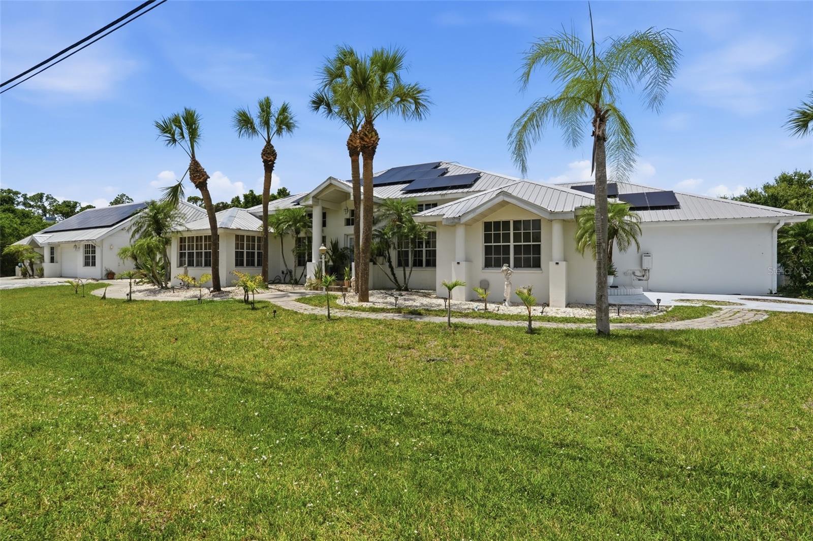 CUSTOM MULTI-GENERATIONAL POOL ESTATE ON OVER 1 ACRE

Rarely does a property offer this much space, flexibility, and opportunity all in one package. This stunning custom-built 4 bedroom, 3 bathroom pool home sits on 4 lots totaling more than 1 acre and is perfectly designed for multi-generational living, large families, or anyone needing extra room for entertaining and storage. With no deed restrictions, there is ample space for RVs, boats, trailers, and recreational toys, while the expansive indoor and outdoor living areas create the ultimate Florida lifestyle. From the oversized pool deck and outdoor cooking area to the upstairs loft space and bonus entertainment room, this property truly has something for everyone.

INTERIOR FEATURES
• 4 bedroom, 3 bathroom home with flexibility to be 5 bedrooms
• Multi-generational layout with potential mother-in-law suite(s)
• Formal living room with sliding doors to the pool area
• Formal dining room
• Eye-catching ceramic tile flooring throughout
• Spacious upstairs loft space ideal for additional living space, office, game area, or playroom
• Large bonus room featuring a half bathroom and bar area
• Bonus room ideal for entertaining, game nights, or man cave setup
• Garden room with skylight
• Wood-burning fireplace
• Bright and spacious layout designed for entertaining

KITCHEN FEATURES
• Spacious kitchen with abundant cabinetry
• Gas stove
• Oversized pantry
• Ample counter and prep space
• Open flow to dining and living areas

PRIMARY SUITE
• Private sitting area
• Two roomy closets
• Granite countertops
• Dual sink vanity
• Garden jacuzzi tub
• Oversized glass block walk-in shower

EXTERIOR FEATURES
• Private screened pool with oversized pool deck
• Pool bathroom with outdoor access
• Separate covered outdoor cooking area
• Storage shed
• Ample parking space
• Room for RVs, boats, trailers, and recreational vehicles
• Additional driveway with private entrance
• Over 1 acre across 4 lots
• Expansive backyard with room for sports and entertaining
• Potential to subdivide or build accessory dwelling
• No deed restrictions

ADDITIONAL HIGHLIGHTS
• Metal roof
• Newly installed energy-saving solar panels
• Ideal property for large families or multi-generational living
• Endless possibilities for entertaining and outdoor enjoyment

LOCATION HIGHLIGHTS
• Convenient access to Interstate 75
• Close to golf courses, marinas, and boating in Punta Gorda
• Near shopping, dining, and entertainment in Port Charlotte
• Short drive to Gulf beaches and waterfront attractions

Schedule your private showing today and experience the endless possibilities this incredible property has to offer.