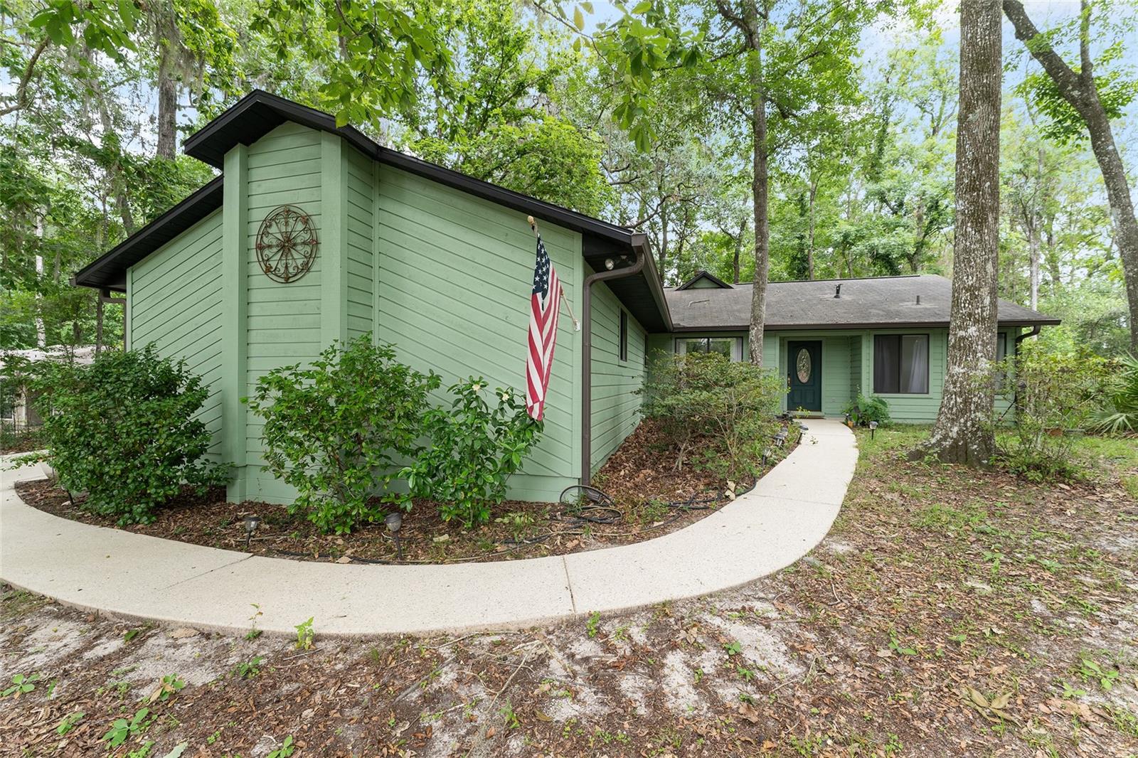 Welcome to Blues Creek, one of Northwest Gainesville's established and sought-after neighborhoods! This lovingly maintained 3-bedroom, 2-bath home offers 1,586 square feet of living space on a quiet cul-de-sac lot with a natural, private backyard. Step inside to a spacious foyer that flows into the dining and living areas, where a wood-burning fireplace serves as the focal point of the space. French doors flank the fireplace and open to a screened back porch — perfect for relaxing and enjoying the natural backyard views. Just beyond, a deck provides additional outdoor living space ideal for entertaining. The eat-in kitchen has newer stainless steel appliances and connects to a dedicated laundry room with storage cabinets and direct access to the two-car garage. The split floor plan offers privacy for all. The primary suite is tucked away at the back of the home and features a large walk-in closet, a spacious en-suite bath with a walk-in shower, separate soaking tub and linen closet. The two secondary bedrooms are on the opposite side of the home and share a hall bath with tub/shower combo. New garage door, roof (2012), HVAC (2020), and water heater (2016). Additional features include IQ Fiber internet, gutters, ceiling fans throughout and a radon mitigation system.  Waiting for your personal touch! Conveniently located near shopping, dining, parks and walking trails, with an easy commute to UF, Shands, and HCA North Florida.
