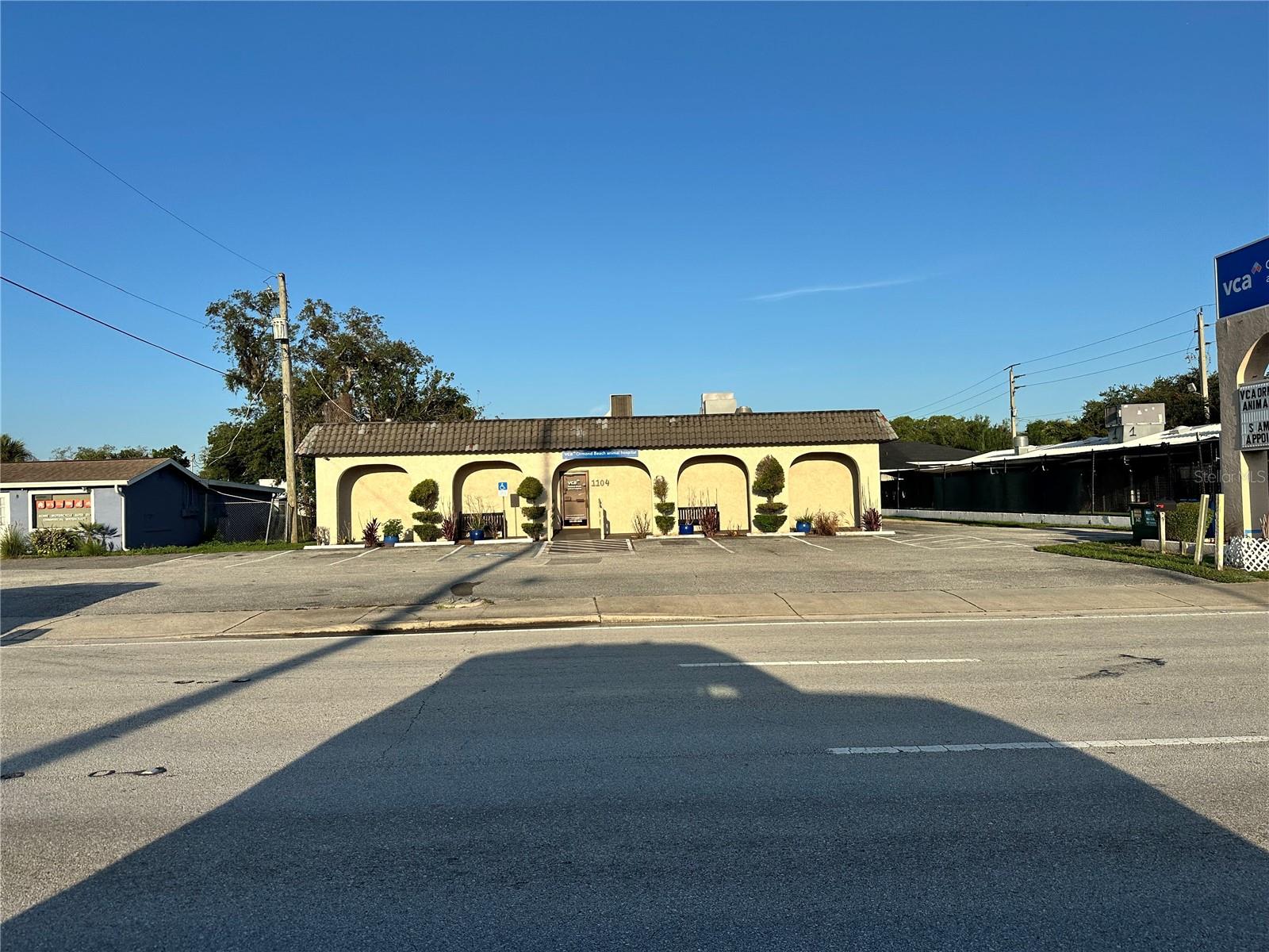 Commercial building FOR SALE! Currently used as a veterinary clinic, this versatile property offers endless possibilities for conversion or continued use. Ideally located directly off S Nova Road in Holly Hill, this high-visibility location provides excellent exposure for your business. The front of the building features prominent signage opportunities in two locations, along with a paved and marked front parking lot. Upon entering, you are greeted by a spacious waiting area with an open reception workspace, creating a functional and welcoming front office setup. Just off the waiting room is a half bathroom that’s currently being used for client use. Down the main hallway, the layout continues with three private exam rooms that can easily serve as individual offices or treatment rooms, along with a dedicated x-ray room that could be repurposed for specialized work or storage. There is also a private office space and two additional flexible common areas that can be adapted for administrative use, team workstations, or consultation rooms depending on your business needs. The building also includes two separate kitchen areas, offering excellent functionality for staff. One kitchen is fully equipped with a sink, cabinetry, and refrigerator, while the second provides additional sink and cabinetry space. There is another half bath that's currently being used for employees. At the rear of the property, you’ll find additional parking that provides convenient access for staff or overflow vehicles. A covered carport area adds extra utility and includes a dedicated space with a washer and dryer, as well as additional storage options for equipment, supplies, or maintenance needs. This is a fantastic opportunity in a prime location, don’t miss your chance to bring your business vision to life. Come see it today!