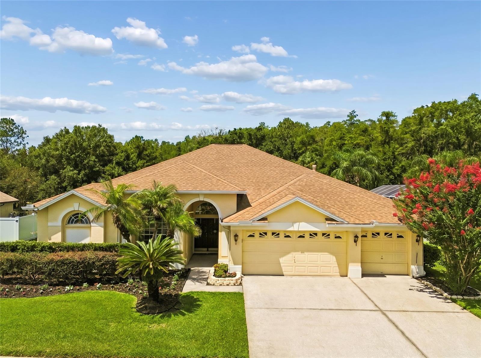 Welcome to the highly sought-after gated community of Kingshyre in New Tampa, where luxury, privacy, and convenience come together in one of the area's most desirable locations. Built by Southern Crafted Homes, this popular Islamorada floorplan offers 4 bedrooms, 3 full bathrooms, a dedicated office or den, a private screened pool, outdoor kitchen, oversized lanai, attached outdoor storage room, and a 3-car garage with the added benefit of NO CDD fees and a low HOA.

Positioned on a premium homesite overlooking a tranquil pond and conservation area, this beautifully maintained home offers exceptional outdoor living and peaceful water views surrounded by mature landscaping. The resort-style swimming pool was completely renovated in 2026, creating the perfect setting for entertaining or relaxing while enjoying the Florida lifestyle.

The thoughtfully designed split-bedroom floorplan provides privacy and functionality for families and guests alike. The spacious primary suite serves as a private retreat and features a walk-in closet and a luxurious ensuite bathroom with dual vanities, marble countertops, a soaking tub, walk-in shower, and linen closet. Bedrooms two and three share a full bathroom, while the fourth bedroom offers its own private bath that also serves as a convenient pool bath with direct access to the outdoor living area.

The private office or den features double-door entry and is ideally situated away from the main living spaces, making it an excellent option for a home office, library, or flex space.

At the center of the home is a large chef's kitchen overlooking the family room and outdoor entertaining areas. The kitchen features abundant cabinetry, extensive counter space, a breakfast bar with additional seating, a spacious dinette area, and a pass-through window to the lanai that makes indoor and outdoor entertaining effortless.

The expansive family room opens to the covered lanai through triple sliding glass doors, seamlessly blending indoor and outdoor living spaces. Additional interior features include a formal dining room with tray ceiling detail, wood flooring in the formal living areas, luxury vinyl throughout the kitchen and family room, and a large laundry room complete with utility sink and additional storage.

Kingshyre is one of New Tampa's premier gated communities and is located near highly rated elementary and middle schools. Residents enjoy convenient access to Interstate 75, the University of South Florida, Moffitt Cancer Center, the James A. Haley Veterans Hospital, AdventHealth Tampa, USAA, the Shops at Wiregrass, Tampa Premium Outlets, downtown Tampa, and the area's extensive shopping, dining, entertainment, and recreational opportunities. An additional advantage of this location is that Kingshyre is situated just outside the Tampa city limits in unincorporated Hillsborough County, allowing homeowners to benefit from lower county-only property taxes while still enjoying a popular New Tampa address and quick access to everything Tampa and Wesley Chapel have to offer.

If you are searching for a luxury pool home in New Tampa with water views, conservation views, a gated community setting, a 3-car garage, no CDD fees, lower property taxes, and easy access to Tampa's major employment centers, 10111 Kingshyre Way offers a rare opportunity to enjoy the best of Florida living.