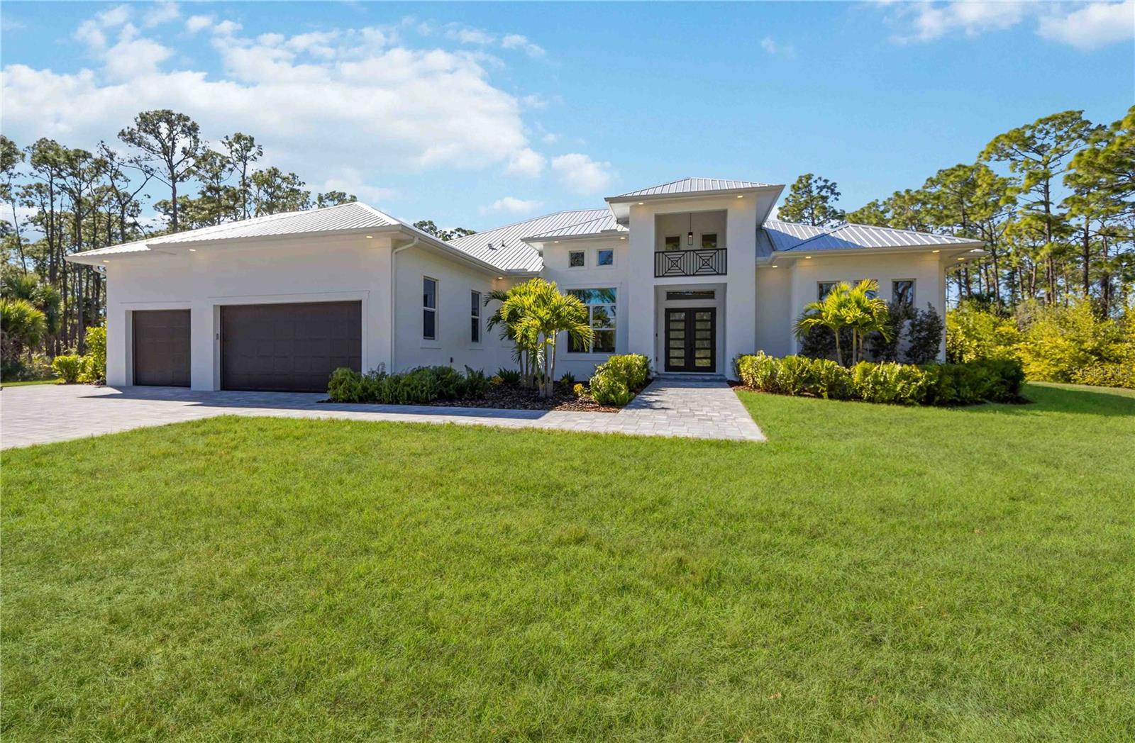Pre-Construction. To be built. This is a rare opportunity to secure a true legacy estate. The list price includes both the $1,000,000 homesite situated on Charlotte Harbor with breathtaking 300-foot panoramic views and the $1,220,000 construction of your custom pool home. Offering ultimate flexibility, the magnificent Venetian Grande floor plan can be tailored to your precise specifications or constructed on your own private lot. Featured photographs showcase The Venetian Grande model home alongside the spectacular waterfront parcel. Private showings of the model are available by appointment—contact the listing agent today to bring your vision to life.
Welcome to The Venetian Grande, a bespoke waterfront masterpiece with a 14-month build time. This avant-garde estate blends sophistication with architectural grandeur. The 4-bedroom plus den/office and bonus room, 3.5-bath, 3-car garage sanctuary boasts 4,075 sqft of air-conditioned luxury, 6,334 sqft total, and an 8,000 sqft footprint including a resort-style saltwater pool and spa designed for the ultimate entertainer.
The experience begins at the double door entrance, where you are greeted by a soaring 20-foot foyer that gives way to 12-foot 8” ceilings throughout the entire home.  Also found throughout are warm yet industrial polished concrete floors, and 8 foot interior doors with custom wood casing. The heart of the home is an epicurean kitchen featuring triple-stacked wood cabinetry, exotic Taj Mahal Quartzite countertops, a built-in double oven, and oversized island. A massive custom Venetian plaster hood crowns the space, which transitions into a 12-foot long wine bar. The adjacent living room centers around a 100-inch fireplace framed by an artisan Venetian plaster entertainment center and white oak shelving. Designed to erase the boundary between land and sea, the entire rear of the home opens via 10-foot, 90-degree pocketing sliders.
The master suite is a secluded sanctuary tucked away for maximum privacy. This retreat features dual walk-in closets, a cozy seating area, custom window trim, white oak beams, and French doors with sidelights. The spa-like master bathroom redefines luxury with his and hers vanities, vessel sinks, and a massive walk-in shower finished in waterproof Venetian plaster for a sleek "zero grout line" aesthetic. The thoughtfully designed split plan includes a Jack-and-Jill suite for two guest bedrooms, while a third guest room features an en-suite that doubles as a pool bath. Every bathroom is elevated with Taj Mahal Quartzite and soft-close solid wood cabinetry. Even the oversized laundry room exudes elegance with cabinets galore, a farmhouse sink, and white oak shelving. For leisure, the vibrant bonus room features a built-in console and dual pocket sliders that join the interior with the outdoor kitchen, outdoor shower, and pool area.
The exterior is an entertainer’s paradise designed for year-round enjoyment. The expansive under-truss lanai provides ample room for lounging and dining, leading to an extraordinary 40-foot resort-style pool with versatile sun shelves and an oversized hot tub that comfortably accommodates 20 guests. An al-fresco culinary suite completes the experience, featuring a hibachi grill, mini-fridge, ice-maker, farmhouse sink, and dishwasher under a custom Venetian plaster vent hood and beautiful Dolomite countertops. From the flawless finishes to the unrivaled 300-foot water views, The Venetian Grande is a rare opportunity to secure a legacy property.
