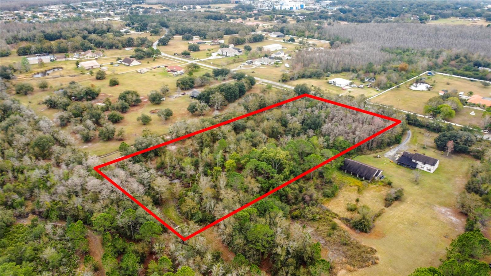 Discover a rare opportunity to own 5 acres of undeveloped land in the heart of Kissimmee — perfect for residential development, ranching, agricultural use, or your private estate. This parcel offers privacy with convenient access to city amenities, major roadways, and Central Florida attractions. Close to schools, hospitals and shopping.