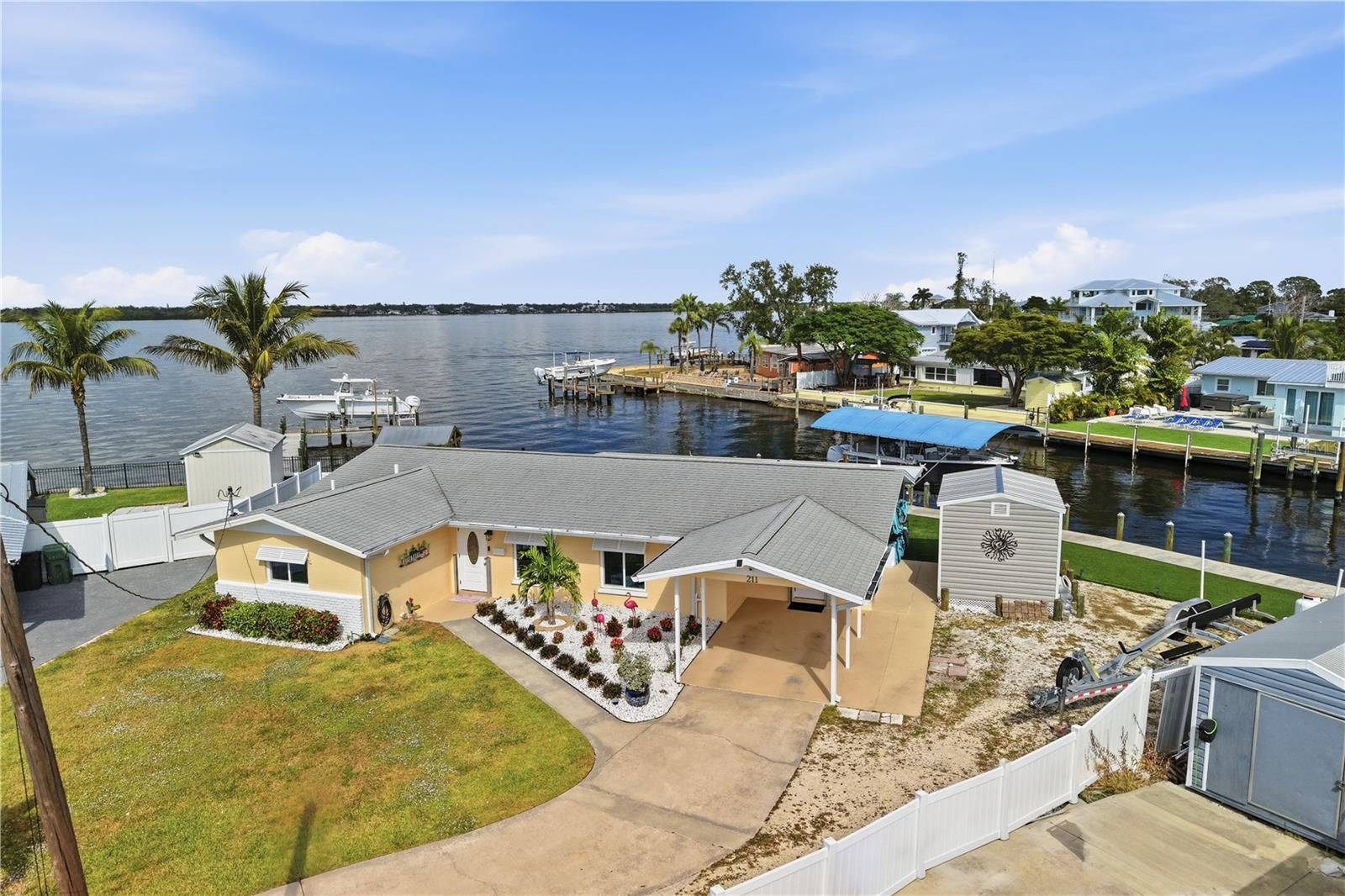 A Boat Owner's Dream and being sold TURNKEY FURNISHED!  NO HOA and NO deed restrictions. Your boat will have easy access to the Manatee River, Tampa Bay and the Gulf with a 10,000lb boat lift, making this home a dream come true for anyone who loves the water. This beautifully updated single-family home has been completely renovated, with no detail left out. Including new plumbing and drain lines, updated electric, new AC and ductwork, all in 2020. The inside and outside were freshly painted in 2024, and the classic Bermuda shutters add a touch of charm and coastal flair. Inside, the open-concept floor plan is bright and airy, with LED ceiling lighting and stylish shiplap accents for a subtle nautical vibe. The fully updated kitchen boasts a gas range, sleek quartz countertops, and a complete stainless steel appliance package (2024). Step outside to a stunning backyard with low-maintenance, lush Astroturf, a gazebo with fire pit —perfect for relaxing or entertaining while enjoying the peaceful water views. Garrison flood panels have been installed on all openings.
