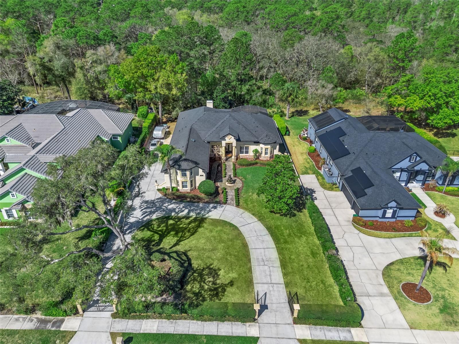 Welcome to 814 Miami Springs Drive, an exceptional private estate nestled in one of Longwood’s most desirable locations near the Wekiva River and Wekiva Island. Positioned on a beautifully landscaped homesite backing to a tranquil natural preserve, this residence offers a rare blend of elegance, privacy, and resort-style living with no HOA restrictions.

This impressive five-bedroom, five-bathroom residence with a loft was thoughtfully designed with both comfort and sophistication in mind. From the moment you enter, the home showcases soaring ceilings, expansive living spaces, and refined architectural details that create an inviting yet grand atmosphere.

The main living areas flow effortlessly, providing an ideal setting for both everyday living and entertaining. The spacious chef’s kitchen features a large center island, generous cabinetry, and seamless connection to the surrounding living and dining areas, allowing gatherings to feel both open and intimate.

The primary suite serves as a private retreat, offering a luxurious bathroom complete with dual vanities, a soaking tub, walk-in shower, and generous closet space designed for comfort and functionality. Upstairs, a versatile loft space provides endless possibilities and could function beautifully as a media room, executive home office, or additional lounge area.

Outside, the home transforms into a private outdoor sanctuary. A screen-enclosed resort-style pool and spa are framed by an expansive covered lanai, creating a perfect setting for relaxation and entertaining while overlooking the lush preserve beyond. With no rear neighbors, the backyard delivers a level of privacy that is increasingly rare while still being moments from everyday conveniences.

The home offers five spacious bedrooms, five bathrooms, and a flexible loft layout, all complemented by grand ceiling heights, elegant architectural detailing, and thoughtfully designed living areas. The preserve backdrop enhances the sense of tranquility, while the screened pool and outdoor living space allow you to fully embrace the Florida lifestyle.

Located just minutes from Wekiva Island, Wekiva Springs State Park, scenic trails, dining, and shopping, this property offers a lifestyle centered around nature, privacy, and refined living.

A rare opportunity to own a luxury estate near the Wekiva River where space, tranquility, and convenience come together seamlessly.