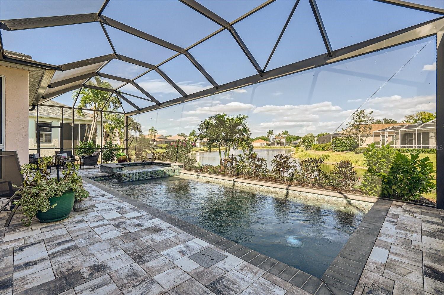 Discover the rare opportunity to own a stunningly renovated single-family pool home with a serene lake view in the highly sought-after neighborhood of Perico Isles. This exceptional residence epitomizes the quintessential Florida lifestyle with its expansive open floor plan and vaulted ceilings that enhance the sense of space and light. A bank of sliders along the back of the home seamlessly merges indoor and outdoor living, offering a magnificent view of the pool, spa, and sparkling lake beyond. It is here that you will want to sit and sip your coffee as the sun rises over Robinson's Preserve. The 679-acre nature Preserve of coastal grasslands and marshes is accessible through a path located just outside this community. The perfect spot to walk, bike ride, kayak and paddleboard or simply bird watch. Inside the home the chef-inspired kitchen, featuring a large center island, which is perfect for entertaining. Every detail of this luxurious home has been meticulously updated, including coastal laminate flooring, designer tile, professional-grade appliances, and high-end finishes and fixtures, such as electronic sunshades. The master bath rivals any five-star spa, boasting a generous soaking tub, walk-in shower, and dual sinks. The outdoor area is a true oasis, with beautiful paver bricks and coastal glass tiles surrounding the saltwater, solar-heated pool. The pool screen has been updated with no-see-um screens. Freshly painted on the outside, the home also has new coastal tolerant landscaping package. Perico Isles is an island gem with public beach is just a hop-skip & jump away! The area is renowned for its fine dining, world-class boating and fishing, golf, tennis, and pickleball facilities, and cultural entertainment. The Perico Isles community provides a clubhouse, fitness center, tennis courts, a community pool, saunas and lawn maintenance, all for a nominal fee. This home is a perfect blend of luxury and convenience, presenting a unique, once-in-a-lifetime opportunity for its new owners to enjoy the best of life surrounding the barrier island and Florida Gulf Coast!