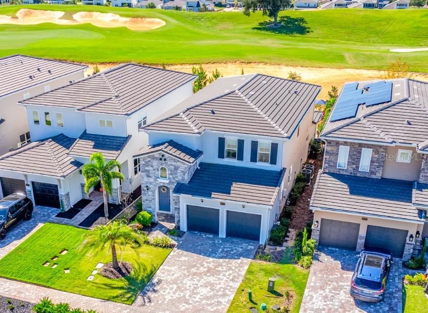 Ask about a lender provided RATE BUY-DOWN CREDIT on this home / Seller may consider buyer concessions if made in an offer ~ Welcome to luxury redefined in the highly sought-after, guard-gated golf community of Bella Collina – Orlando’s premier lakefront and golf destination! Set on a prime GOLF COURSE LOT, this 2022 BUILT modern retreat feels brand new, offering the perfect balance of elevated living and RESORT STYLE AMENITIES. Step inside to discover a fresh, thoughtfully designed interior with an OPEN CONCEPT layout that flows effortlessly from the chef’s kitchen to the living and dining areas. The kitchen is a dream come true – elegant custom cabinetry, crown molding, chic fixtures, sleek countertops, a backsplash that complements it all perfectly, and a large ISLAND with bar seating in a trendy contrasting color. Top-of-the-line STAINLESS STEEL APPLIANCES make this space both functional and beautiful. The MAIN FLOOR OWNER’S SUITE is a serene retreat, privately tucked away with sweeping GOLF COURSE VIEWS, a CUSTOM WALK-IN CLOSET, and a SPA-LIKE BATH with luxurious finishes. Upstairs, you will find spacious bedrooms – each with a walk-in closet, two full baths, and a VERSATILE BONUS/LOFT offering endless possibilities for additional living space, media room, or home office. Step out back to a COVERED LANAI complete with RETRACTABLE REMOTE CONTROLLED SCREENS, a fully equipped SUMMER KITCHEN with a vented hood, and the ultimate outdoor living space overlooking your sparkling HEATED POOL and SPA. The fenced yard backs up to panoramic fairway views – perfect for entertaining or soaking in your peaceful surroundings. Additional highlights include: a TESLA CHARGER in the garage, a whole-home GENERATOR HOOKUP, stone-accented exterior, and a paver driveway framed by lush landscaping for undeniable curb appeal. ****Living in Bella Collina means access to five-star amenities and an incomparable lifestyle spread across 1,900 acres of rare rolling hills and lakes. Residents will enjoy the Sir Nick Faldo designed golf course, scenic walking trails, resort-style pool, full-service spa, fitness center, tennis courts, two world-class restaurants inside the clubhouse, and more!**** Zoned for top-rated schools with easy access to the Florida Turnpike, shopping, dining and area attractions. Schedule your private tour today and experience the harmony of modern luxury and timeless comfort in a home where no detail was missed and every day feels like a vacation. Welcome to Vetta Drive and Bella Collina – where luxury, lifestyle, and HOME SWEET HOME meet!