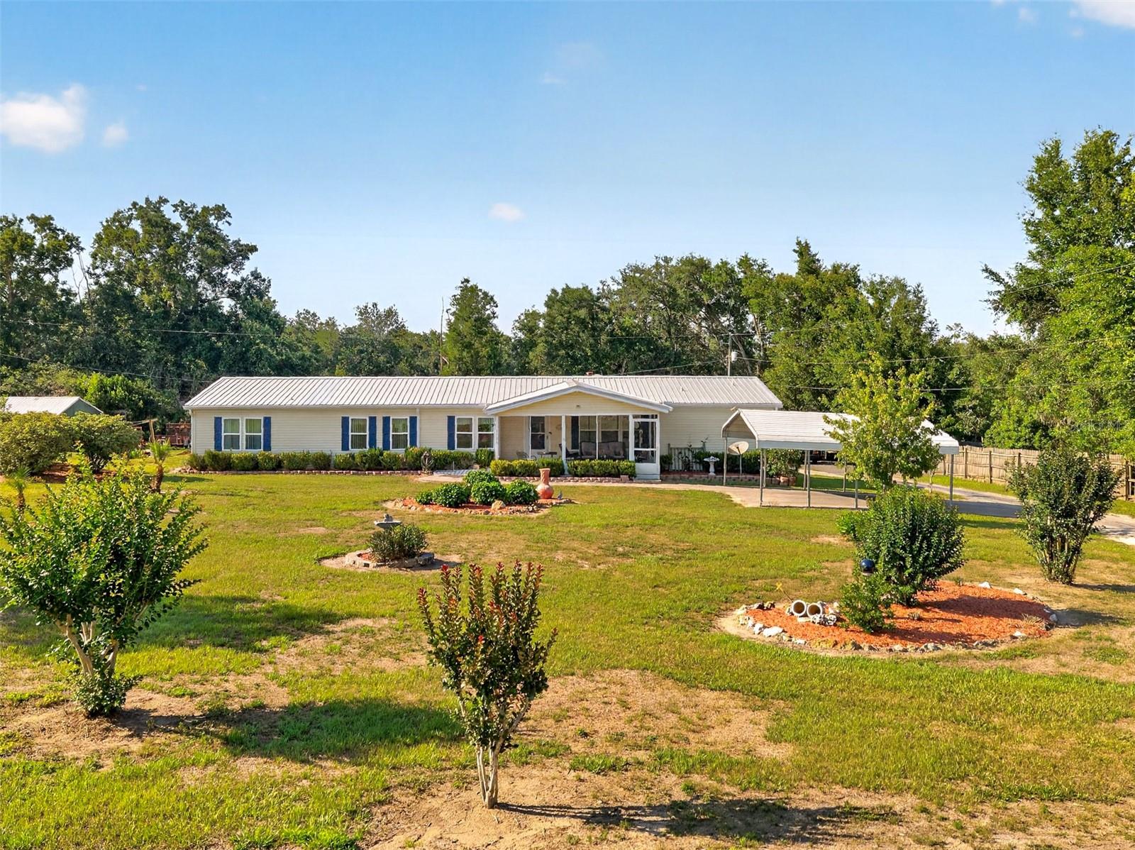 Don't Miss this Versatile Property with Income Potential on 1.10 Acres! Welcome to 9706 US Hwy 301, Dade City, FL — a unique 3 bedroom, 2 bathroom property situated on 1.10 acres, offering space, versatility, and endless possibilities! Whether you're looking for room to spread out, extra storage, or an opportunity for additional income, this property has it all. Inside the main home, you’ll find a warm and inviting layout featuring a beautiful stone fireplace, perfect for relaxing evenings at home. Enjoy Florida living year-round from the front screened porch or the rear porch, ideal for grilling and entertaining family and friends. Major updates include a roof redone in 2018 & a new hot water heater, offering added peace of mind. The property also includes a 2-car carport for covered parking and convenience. A standout feature is the 753 square foot converted garage apartment, offering a 2 bedroom, 1 bathroom space that could serve as an income-producing opportunity, guest quarters, or mother-in-law suite! Need room for hobbies, storage, or equipment? This property delivers with a spacious 30x40 barn plus two additional storage sheds (12x20 & 12x16). The asphalt driveway and millings throughout the rear area and around the barn provide easy access and functionality.  Outside, enjoy thoughtful upgrades including new seamless gutters and a French drain system, along with mature landscaping featuring beautiful crepe myrtles, adding charm and curb appeal to the property. Property Features List: 3 Bedrooms | 2 Bathrooms (Main Home) | 2 Bed | 1 Bath in the Apartment/In-Law Suite 753 sq.ft. | 1.10 Acres | Fireplace | Front Screened Porch + Rear Porch for Grilling | 2-Car Carport | 30x40 Barn |Additional Storage Sheds (12x20 & 12x16) |Asphalt Driveway + Milling| New Hot Water Heater. Whether you’re looking for multigenerational living, rental income potential, extra storage, or room for your hobbies, this property is packed with opportunity! Schedule your private showing today! Also, if you are looking for a family compound or to expand, there is an adjacent parcel with home & barn that is also for sale.