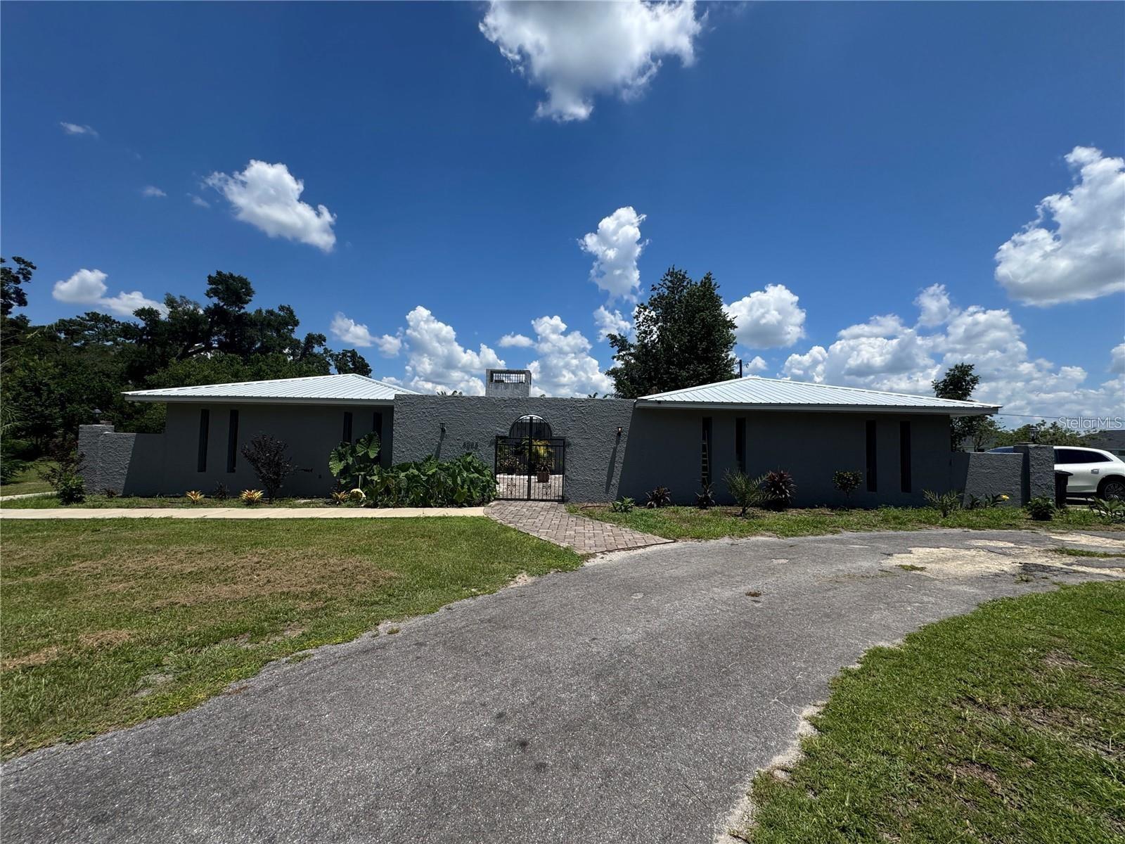 Rare Opportunity: 7.9-Acre Business Flex Site. This expansive, fully cleared parcel offers unmatched versatility with B4 zoning. It features a secure perimeter with multiple strategic access points for seamless logistics. An existing onsite residence is perfectly suited for a professional office or headquarters. Ideal for light industrial, distribution, or mixed-use development."

Key highlights to include:
• Strategic B4 Zoning: Allows for high-intensity commercial and business flex uses.
• Logistical Ease: Dual access points from U.S. Highway 441/301 and NW 47th Street.
• Turnkey Infrastructure: Fully cleared with a 6-foot concrete wall, chain-link fencing, and a professional iron gate.
• Operational Readiness: Includes a concrete block residence for an office and an onsite 4" well.
