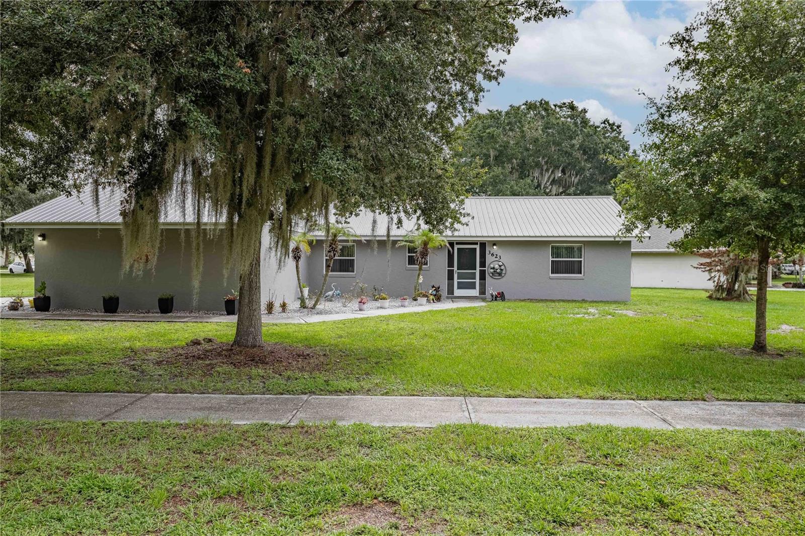 Unwinding as you drive home down the tree lined boulevard and living in a community with a vast array of home styles, are just a couple of the advantages of living in IMPERIAL LAKES.  This property has been IMMACULATELY MAINTAINED and pride of ownership shines through.  It offers a screened front entrance, SPLIT BEDROOM floor plan and CUSTOM TILE FLOORING that flows throughout, creating a clean cohesive look that's easy to maintain. The EAT-IN KITCHEN with a closet pantry, and a pass through to the family room, was designed with GRANITE counters and STAINLESS appliances.  Directly off the kitchen is an INDOOR LAUNDRY room which leads out to the 2-CAR ATTACHED GARAGE with BUILT-IN SHELVING.  The PRIMARY BATH has its own linen closet, MARBLE COUNTERS and a shower with a convenient shower seat and double sinks.  The second and third bedrooms share a full hall bath with MARBLE COUNTERS, linen closet, shower and tub.  All 3 bedrooms, the family room and the kitchen have CEILING FANS.  The CORNER LOT has a SHED, SCREENED LANAI and open patio with brick pavers which includes a large Cantilever umbrella. The back yard is fully fenced. Publix and Dunkin' are both located at the end of the boulevard and Walmart and Aldi are under 15 minutes away. Easy access to Hwy 60, I-4 access, Polk Parkway and County Line Rd.  Also nearby is Lakeside Village outdoor shopping mall and Christina Park which is pet friendly and offers a playground set for the children, sidewalks for walking/running, benches, picnic tables, a screened pavilion, outdoor grills and rest rooms. Imperial Lakes is designed for walking, running, dog walking and bike riding.  It's away from the noise of the city but has such easy access for all your needs.  Call to visit this property, it's a pleasure to show.