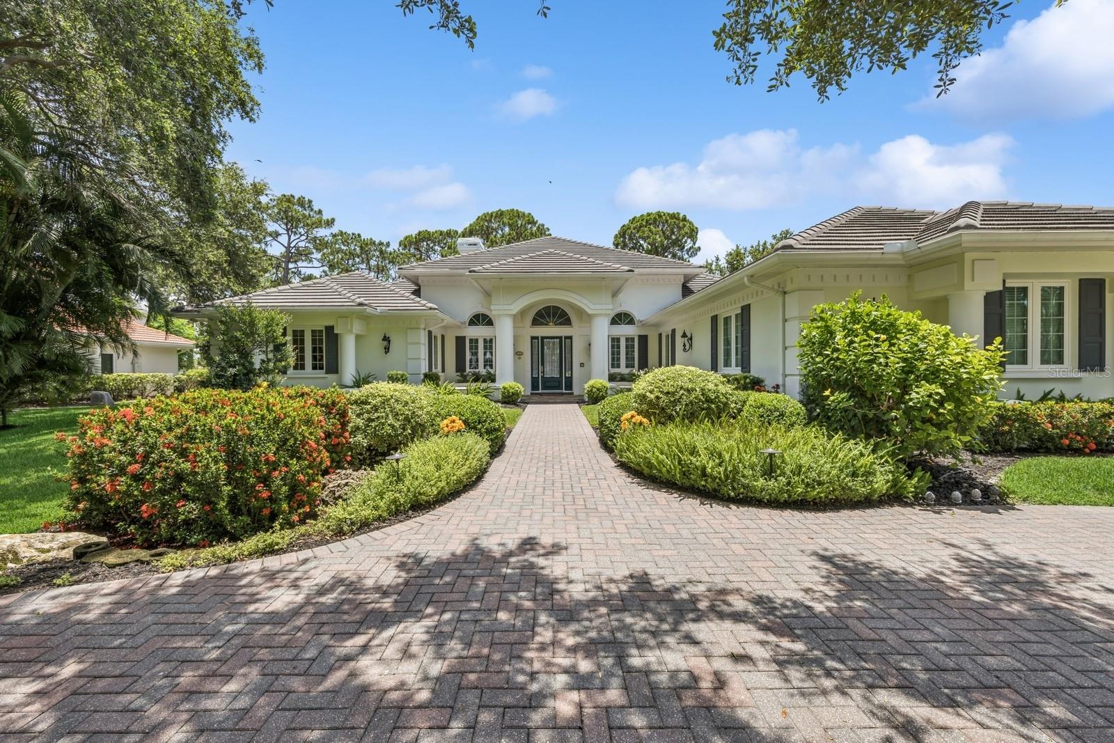 Discover refined living in this extraordinary Georgian-style estate located in the prestigious gated community of TPC Prestancia. Nestled on a rare Southern exposure lot, this residence offers breathtaking lake and golf course views, lush privacy, and timeless architectural charm within one of Sarasota’s most desirable golf communities. Set well back from the street on a gracious circular driveway, this one-story home features a stately front façade with a remarkable symmetry in the architecture, tall windows, mature landscaping, and elegant curb appeal. 

Inside, you’ll find a thoughtfully designed floor plan with 4 bedrooms, including two ensuite guest suites, a private office, formal living room, spacious family room, catering kitchen and laundry room. At the heart of the home is a gourmet chef’s kitchen, open towards the family room and outdoors, fully outfitted with Viking appliances, Subzero refrigerator, plate warmer, wine cooler and high-end finishes like very rich green granite countertops. For effortless entertainment, the residence offers a separate catering kitchen with a second set of appliances. The formal dining room comfortably seats 12 guests, enhanced by custom triple crown molding and refined architectural detail. Entertain in style with two custom wet bars, including a unique Moroccan-inspired bar with a striking blue ceiling—a true conversation piece just off the family room.

The owner’s suite will be your retreat with serene views on the backyard and golf course, a direct access to the pool. Spacious primary bathroom and two California walk-in closets bringing luxury and practicality together.

Same comfort in the three guest bedrooms offering high ceilings, ample storage and relaxing views.

Step outside into a private tropical oasis: a resort-style pool and spa, expansive lanai, and outdoor kitchen are framed by lush backyard. The pool cage was rescreened in 2023, and a charming gated patio with wrought-iron gates offers a secluded nook for peaceful relaxation. This residence is loaded with high-value upgrades and mechanical peace of mind: -Concrete tile roof (2013),Hurricane impact-rated windows (2014), Generator (2018), new water heater (2025), 3-car garage with storage and ample parking space. TPC Prestancia is a premier, gated golf community set on 565 acres of mature landscaping. Recognized as an Audubon Cooperative Sanctuary, the neighborhood is home to vibrant wildlife and peaceful walking paths. Golf membership is optional, with multiple plans available and no waiting list—offering flexibility for both golf enthusiasts and those seeking a serene, upscale environment.

Ideally located in central Sarasota, this Estate is just minutes away from Siesta Key and other Gulf beaches, short drive to downtown Sarasota and Venice and close to sports club, tennis, pickleball courts, YMCA, fine dining, shopping. This exceptional estate blends classic character, modern luxury, and an unbeatable location, making it a true gem in one of Sarasota’s most sought-after golf communities.

Make your appointment today for your private showing!