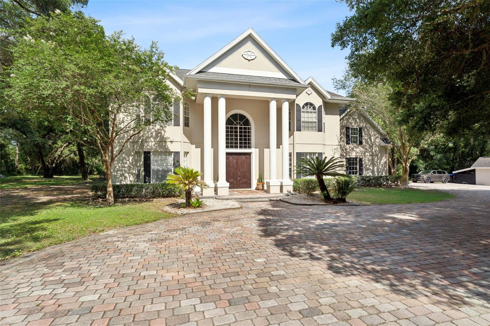 Virtually Staged. Welcome to 4275 Round Lake Road, a rare opportunity to own 10 gorgeous acres of private, gated property in Apopka. Lovingly maintained by its original owners, this exceptional estate offers the perfect blend of comfort, functionality, and wide-open space with no HOA restrictions and no water bill thanks to a private well.

Prepare to be wowed at every turn, the spacious main residence features an inviting open floor plan designed for both everyday living and entertaining. Large gathering areas flow seamlessly together, creating the perfect setting for holidays, celebrations, and making lifelong memories. The heart of this home is the great room surrounded by beautiful windows and French Doors, centered by a lovely brick mantle and one of two wood burning fireplaces. Seamlessly flowing into the built in bar area and kitchen. The primary suite serves as a private retreat, complete with one of two beautiful wood burning fireplaces, a large shower with a steam feature for a spa-like experience right at home and double walk in closets. The main house is equipped with two HVAC systems (2010 & 2018), while the in-law suite offers its own HVAC system installed in 2025, providing comfort and flexibility for multi-generational living, guests, or extended stays. Each bedroom also features walk in closets. 

Step outside and discover a property built for enjoying the Florida lifestyle. The sparkling pool is surrounded by a beautiful brick paver pool deck, creating the perfect setting for relaxing weekends, pool parties, and entertaining under the Florida sun. Whether you're hosting backyard barbecues, reunions, or simply enjoying the peace and privacy of country living, there's room for it all. The property also features a charming playhouse, basketball court, abundant parking, and endless open space to roam. Nature lovers will appreciate the frequent wildlife sightings and tranquil surroundings.

For hobbyists, outdoor enthusiasts, and those seeking versatile workspace, this property truly stands apart. The air-conditioned kennel with a 24' x 16' dog run is ideal for pet lovers, while the impressive 75' x 7' gun range includes an air-conditioned office and kitchenette, creating endless possibilities for recreation, storage, a workshop, or a private retreat. A Guardian generator hookup provides added peace of mind and preparedness.

Offering privacy, flexibility, and room to grow, this one-of-a-kind estate combines the serenity of country living with the convenience of Apopka's shopping, dining, and major roadways. If you've been searching for acreage, versatility, and a property unlike anything else on the market, your search ends here.